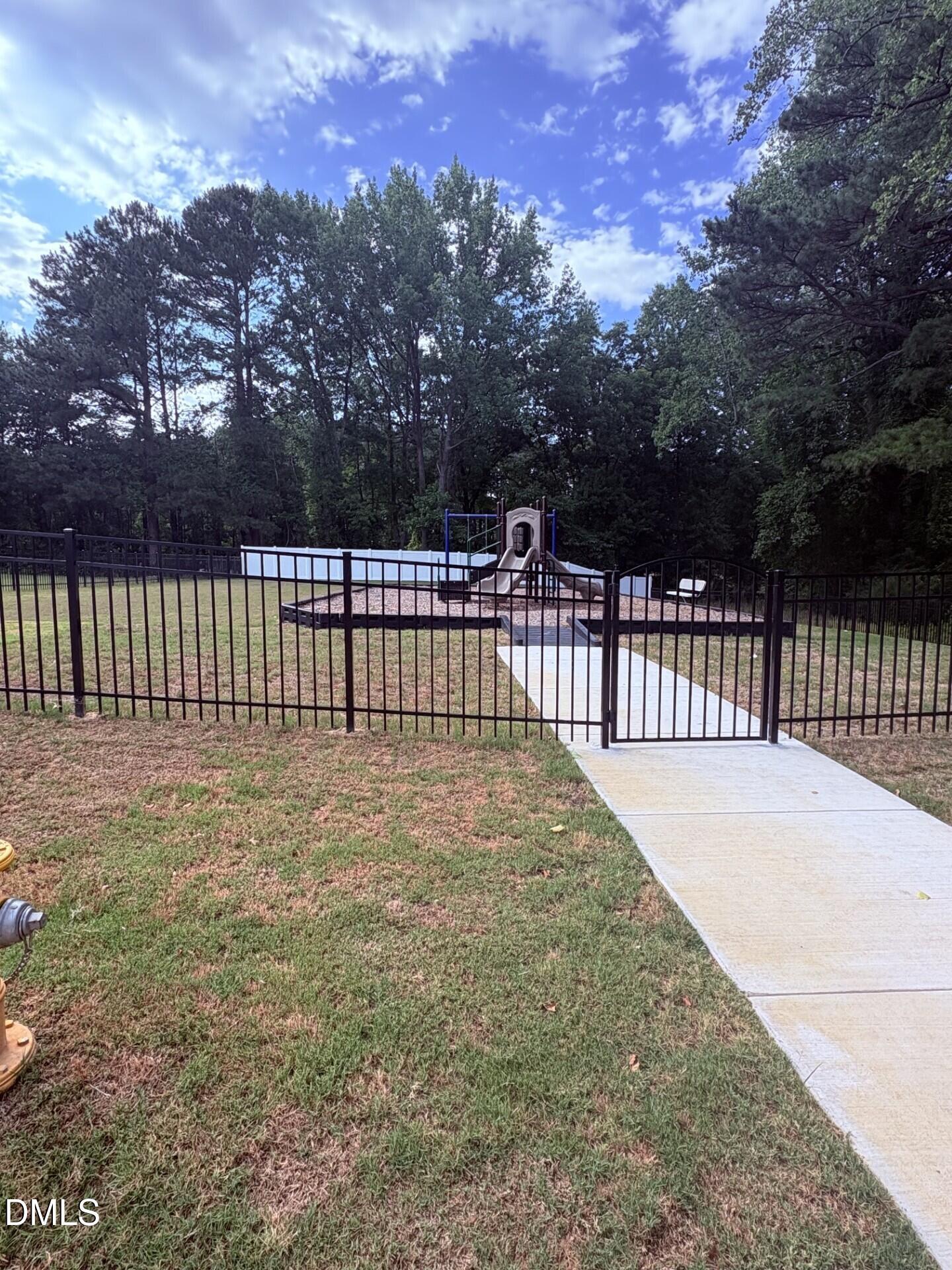 Community playground with slide and swing set at Woodland Crossing in Zebulon, North Carolina.
