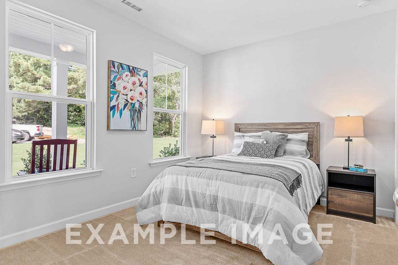 Davidson Homes the Chestnut Plan Bedroom with bed, nightstands, lamps, and wall floral decor