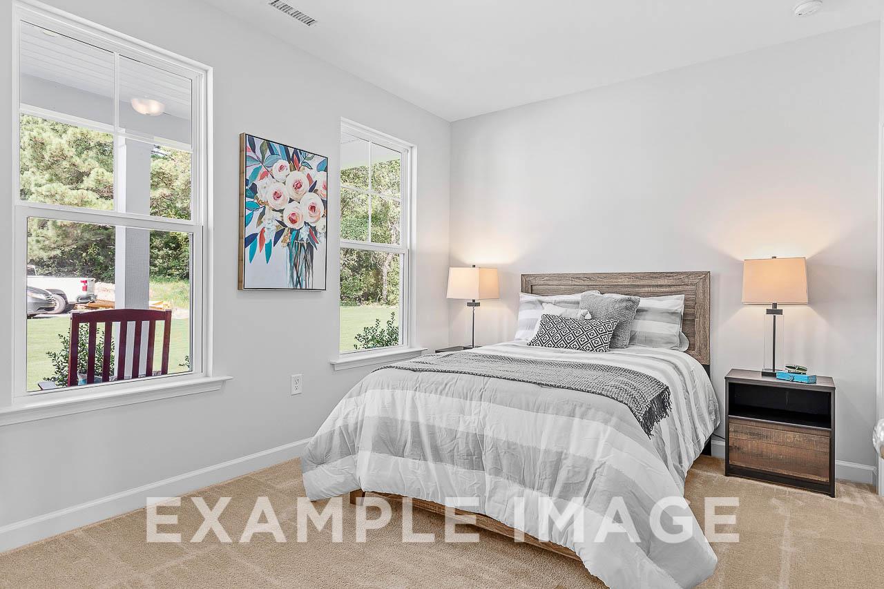 Davidson Homes the Chestnut Plan Bedroom with bed, nightstands, lamps, and wall floral decor