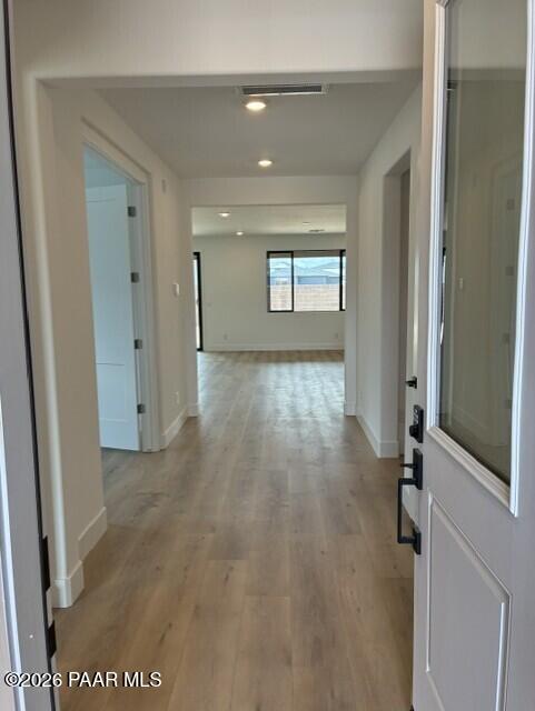 Bright entry hallway with luxury vinyl plank flooring leading to open living area in Davidson Homes Durango II G, Prescott AZ