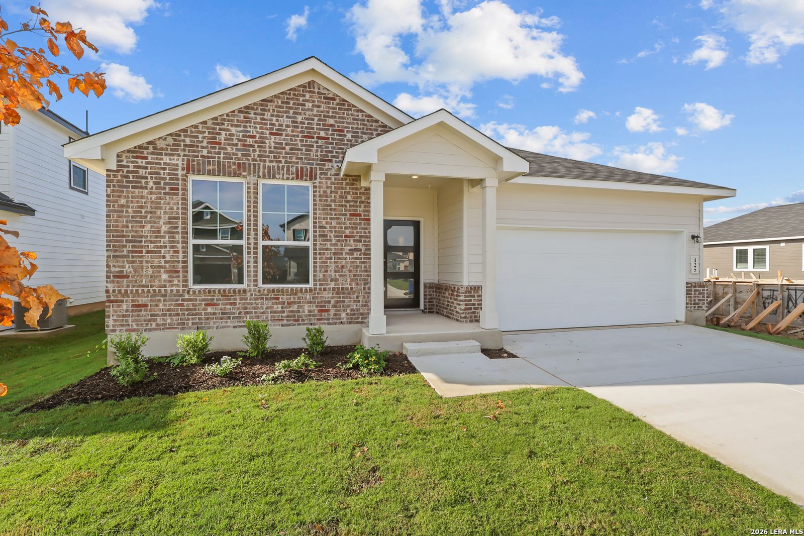 Brick and siding exterior of Davidson Homes' The Daphne H, a 1-story 4-bedroom home with 2-car garage in Hannah Heights, Seguin, Texas