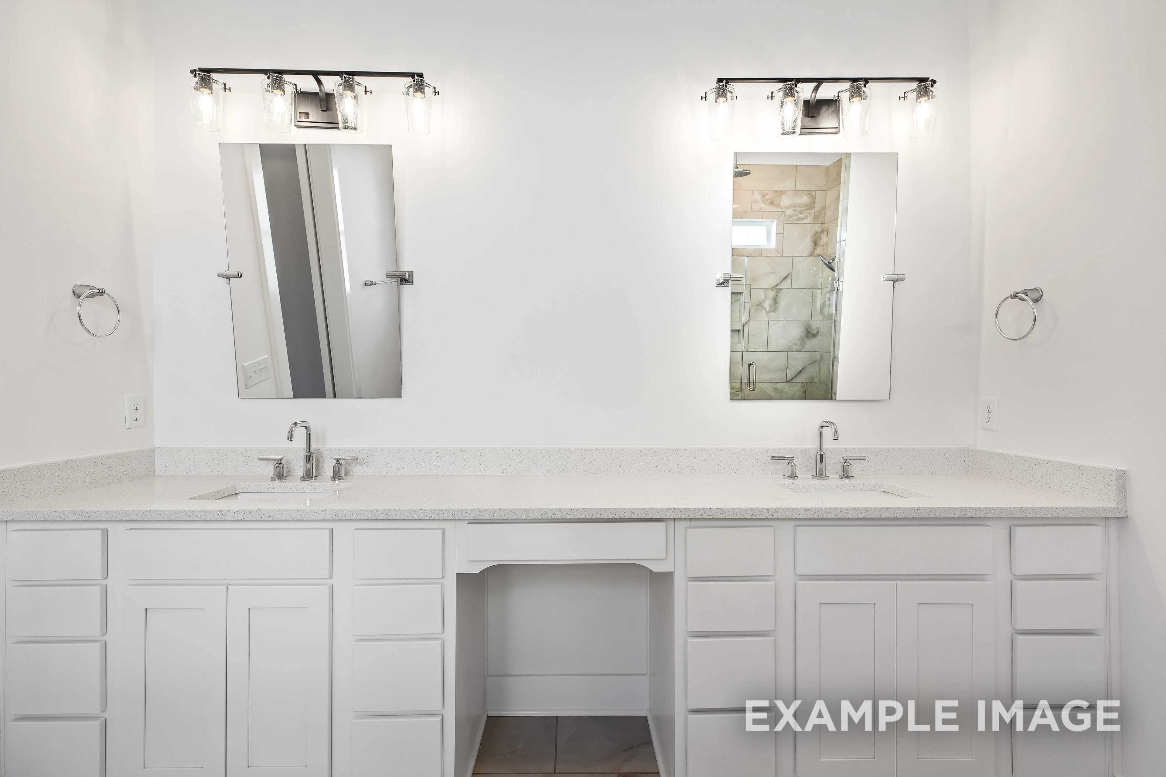 Spacious master bathroom vanity in The Albany A featuring double sinks, white shaker cabinets, quartz countertop, and stone shower