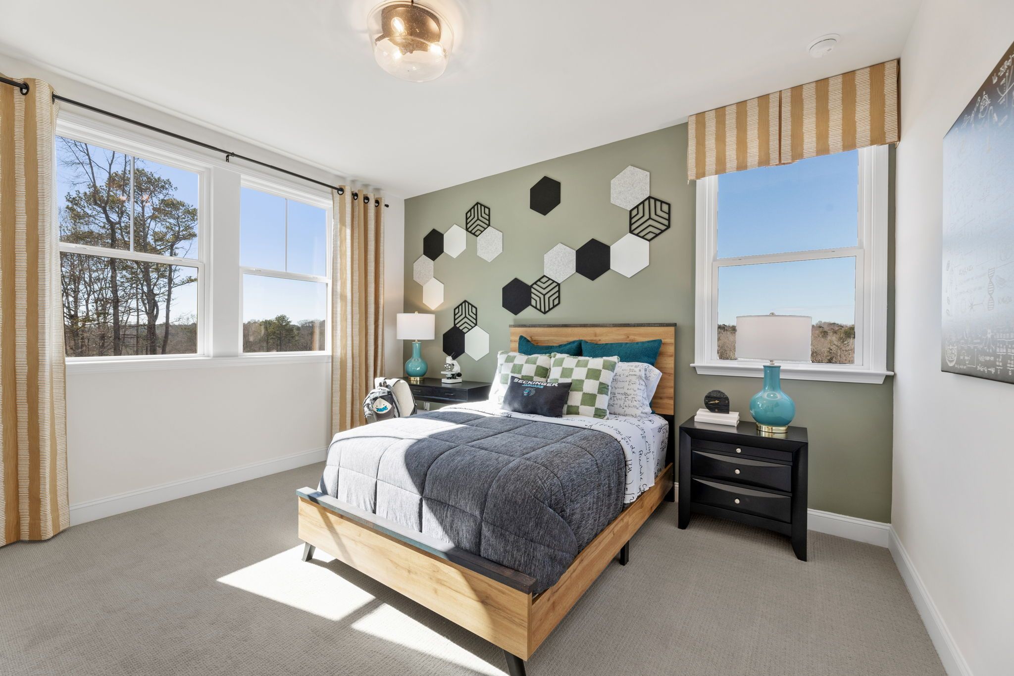 Bright bedroom at Fern Hollow in Buford, Georgia with geometric hexagon wall art, queen bed, and sunny windows