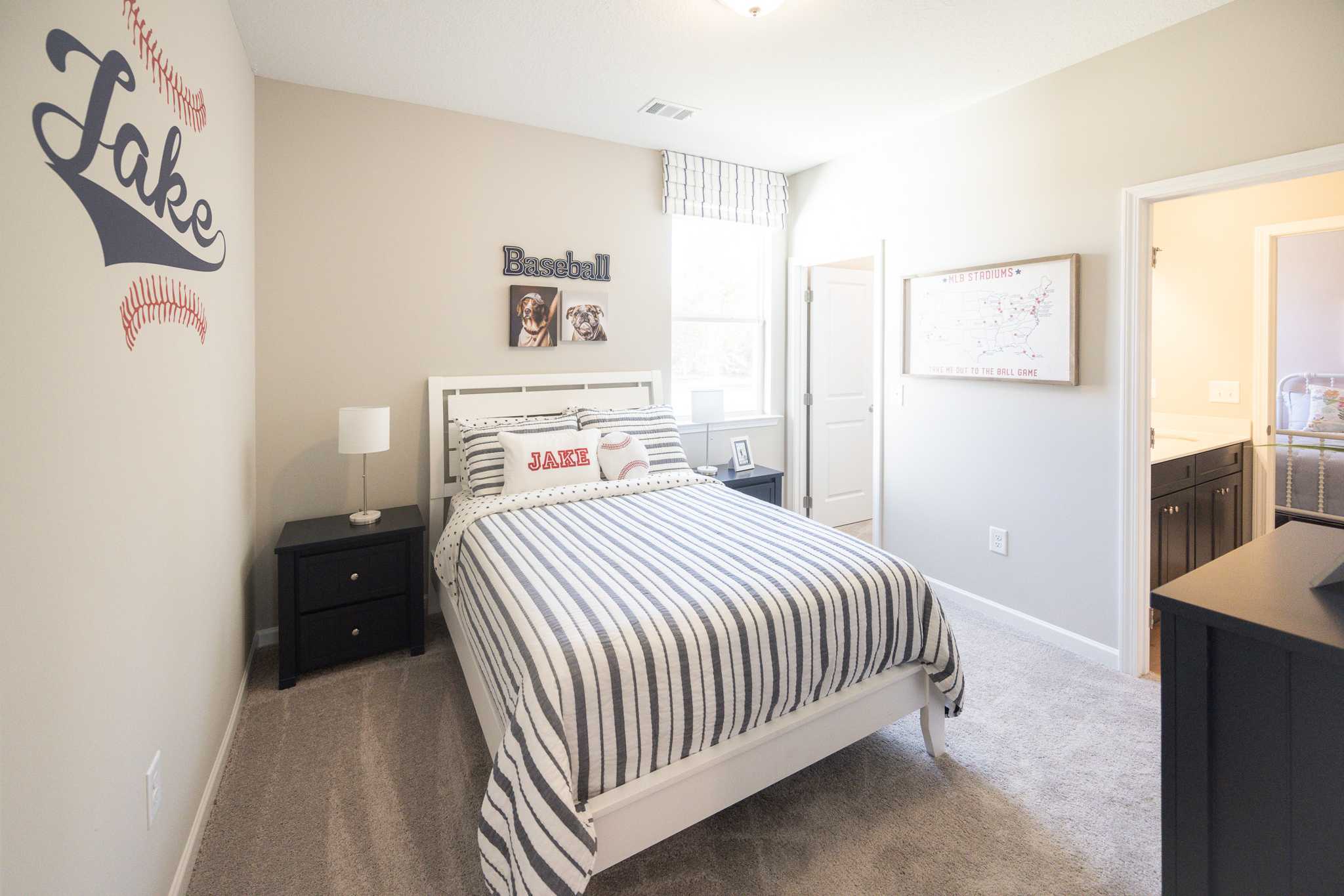 Baseball-themed boy's bedroom at Silver Oak in Cusseta Alabama with Jake wall decal, striped bedding, and baseball decor