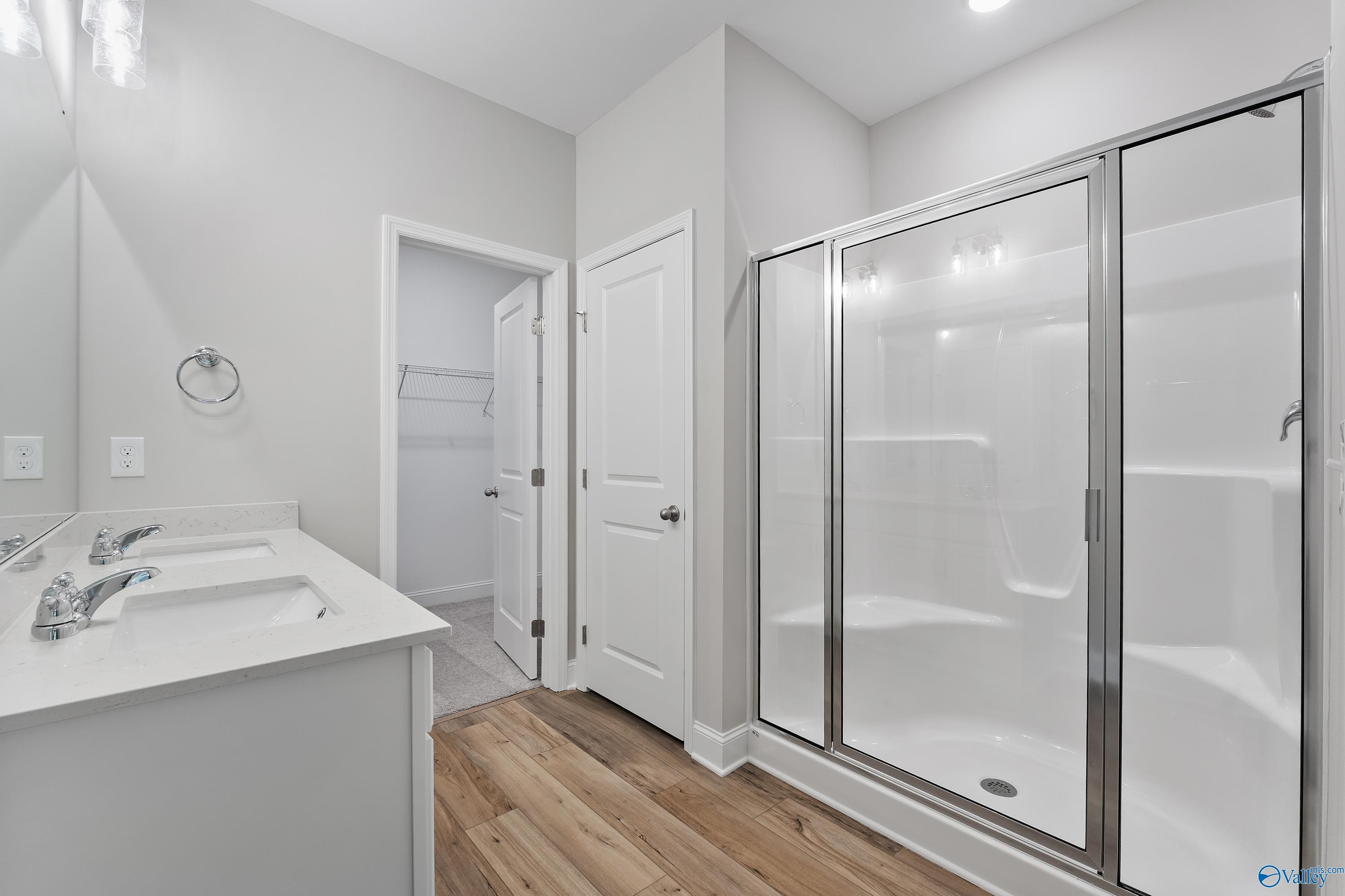 Modern master bathroom with double vanity, frameless glass shower in Davidson Homes The Franklin, Spragins Cove, Huntsville, AL