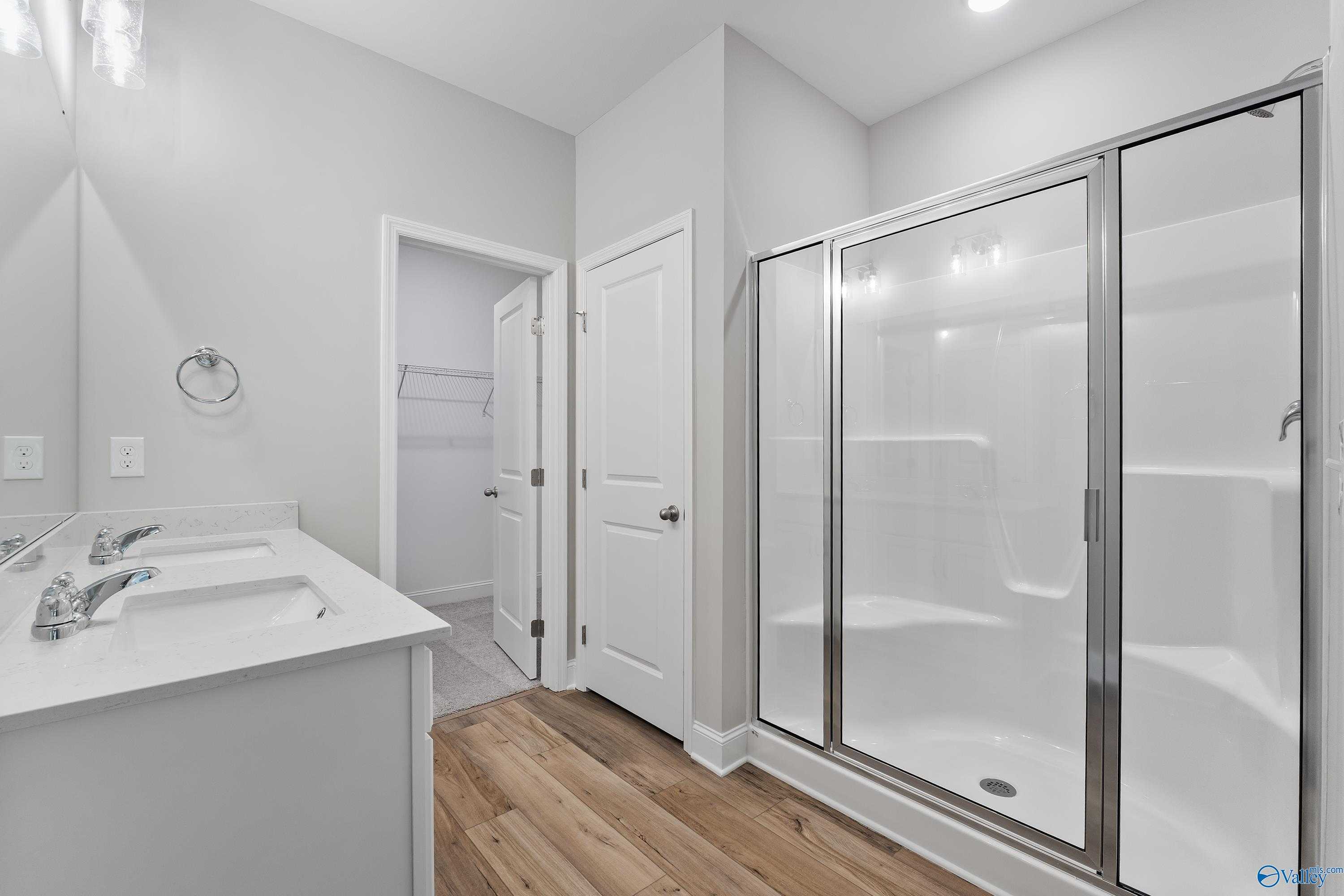 Modern master bathroom with double vanity, frameless glass shower in Davidson Homes The Franklin, Spragins Cove, Huntsville, AL