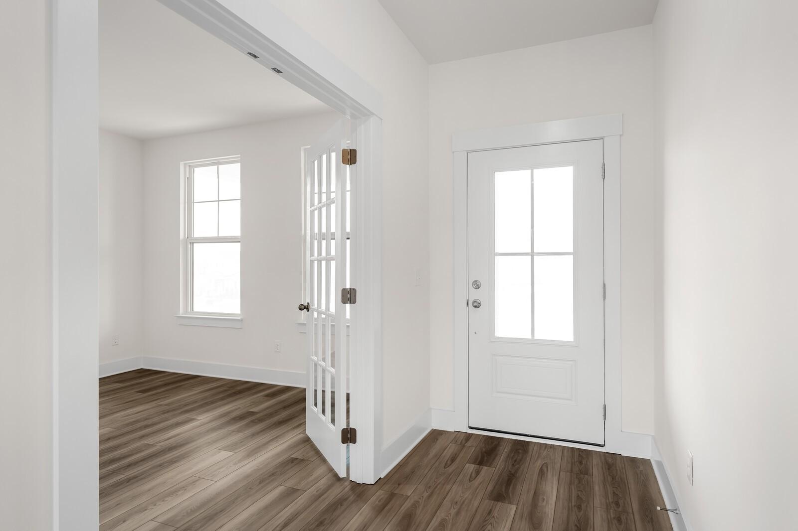 Bright home office with French doors and wood-look flooring in The Henry C floor plan, Benders Cove, Mt. Juliet, Tennessee.