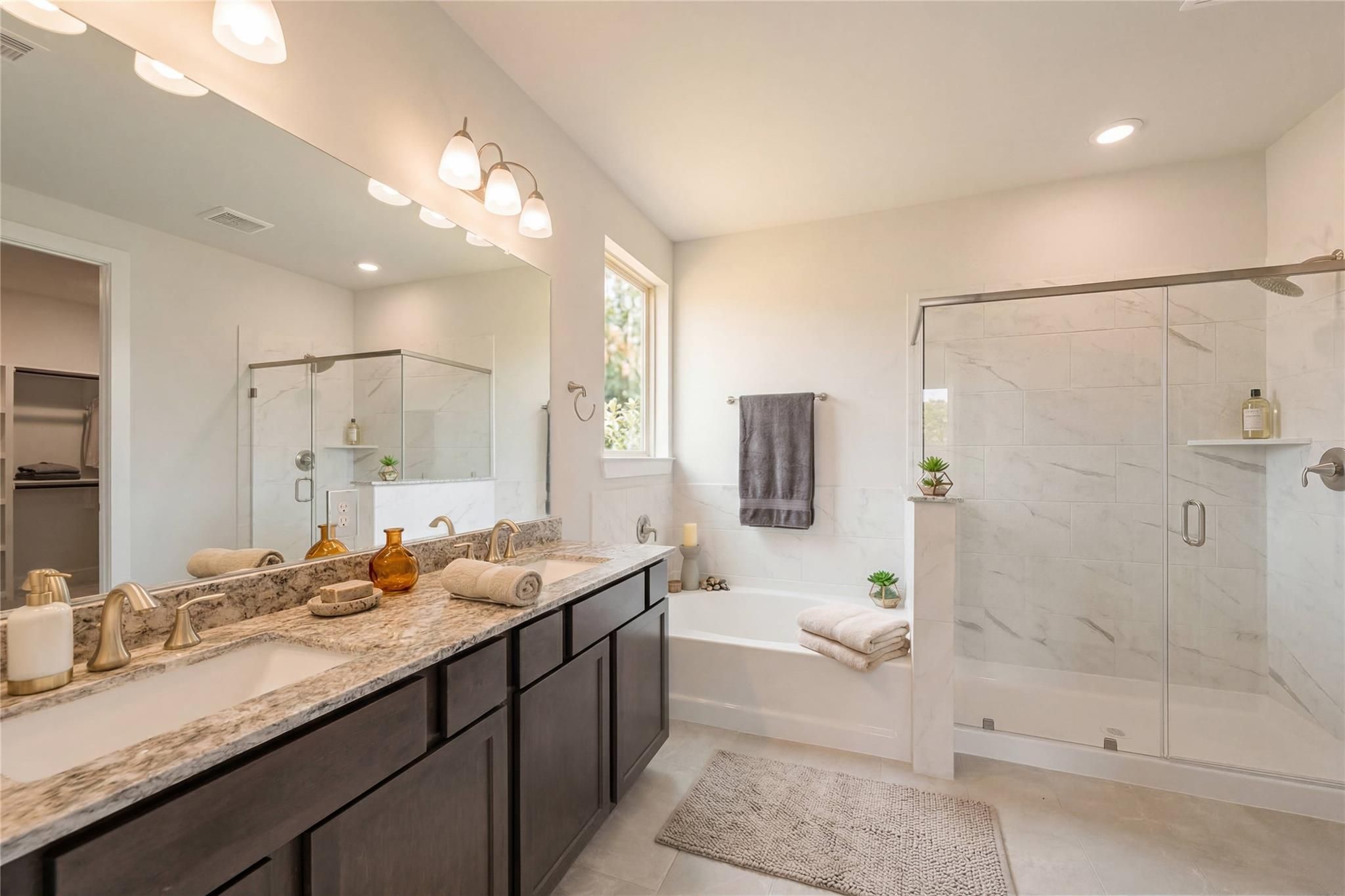 Luxurious master bathroom with freestanding tub, glass walk-in shower, double vanity in Davidson Homes The Philip A, Lago Mar, TX