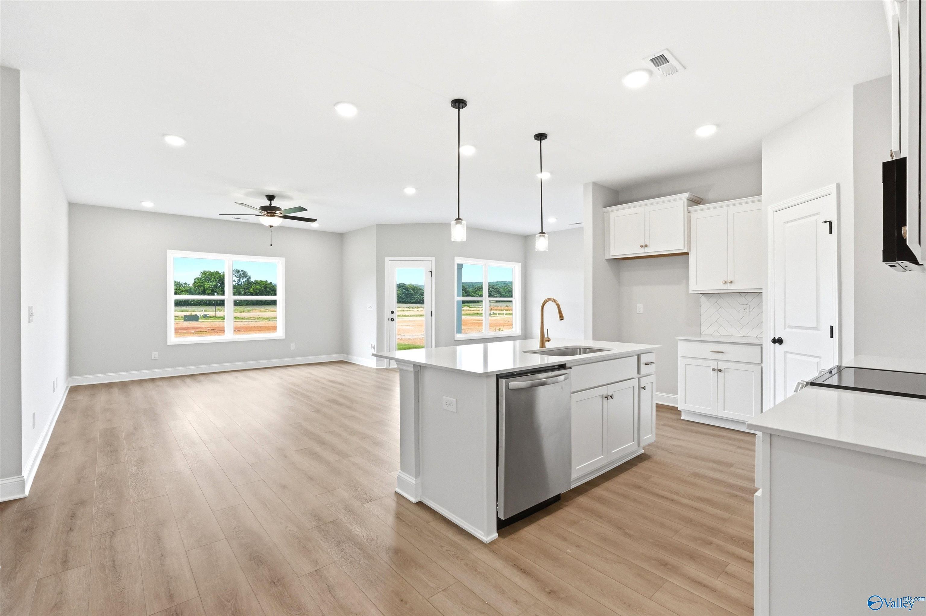 Open-concept kitchen and living area in The Daphne F floor plan, Berry Cove, New Market, Alabama.