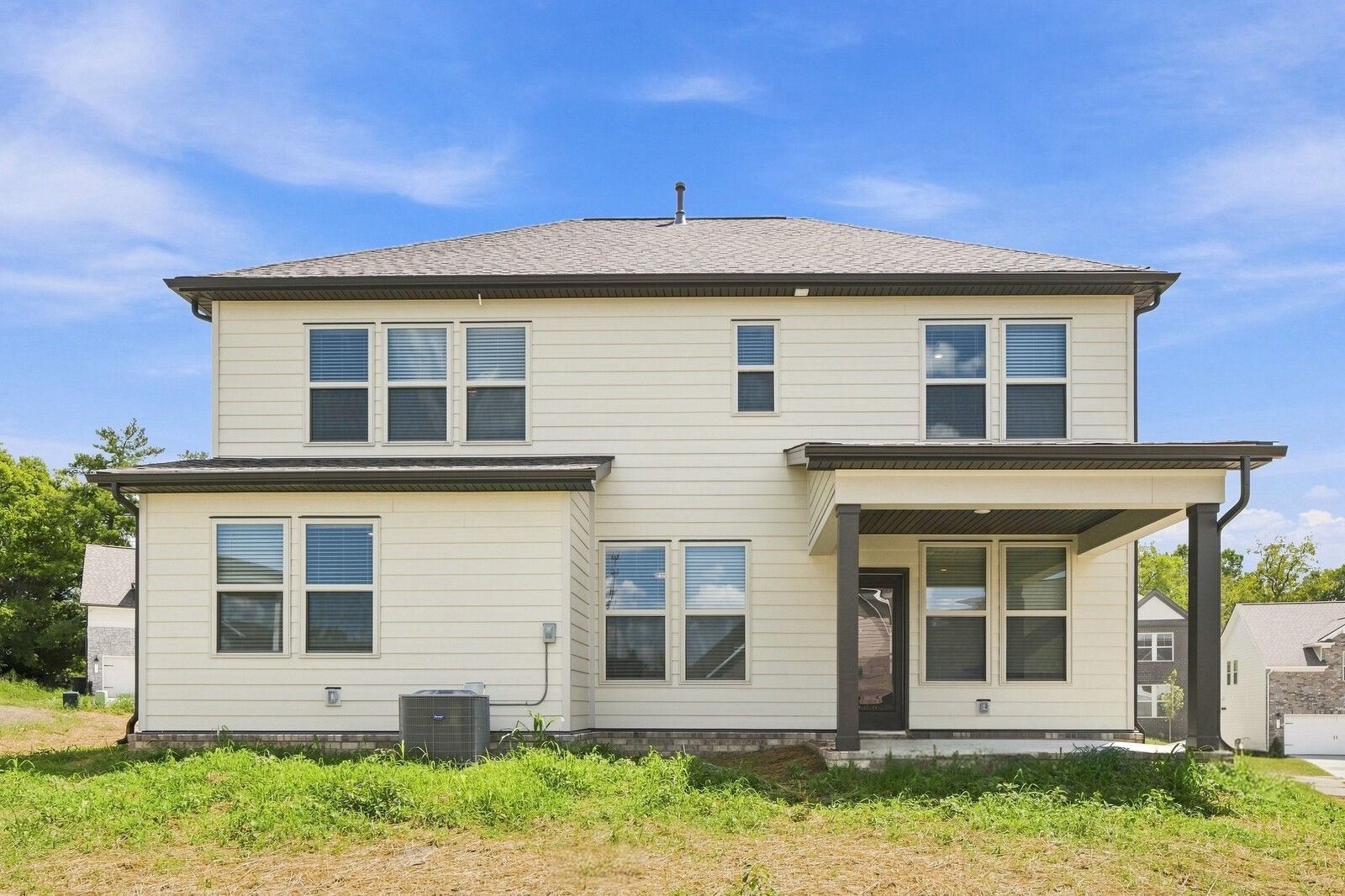 Rear exterior of two-story Davidson Homes Willow C plan with covered patio in Woods Crossing, Gallatin, Tennessee