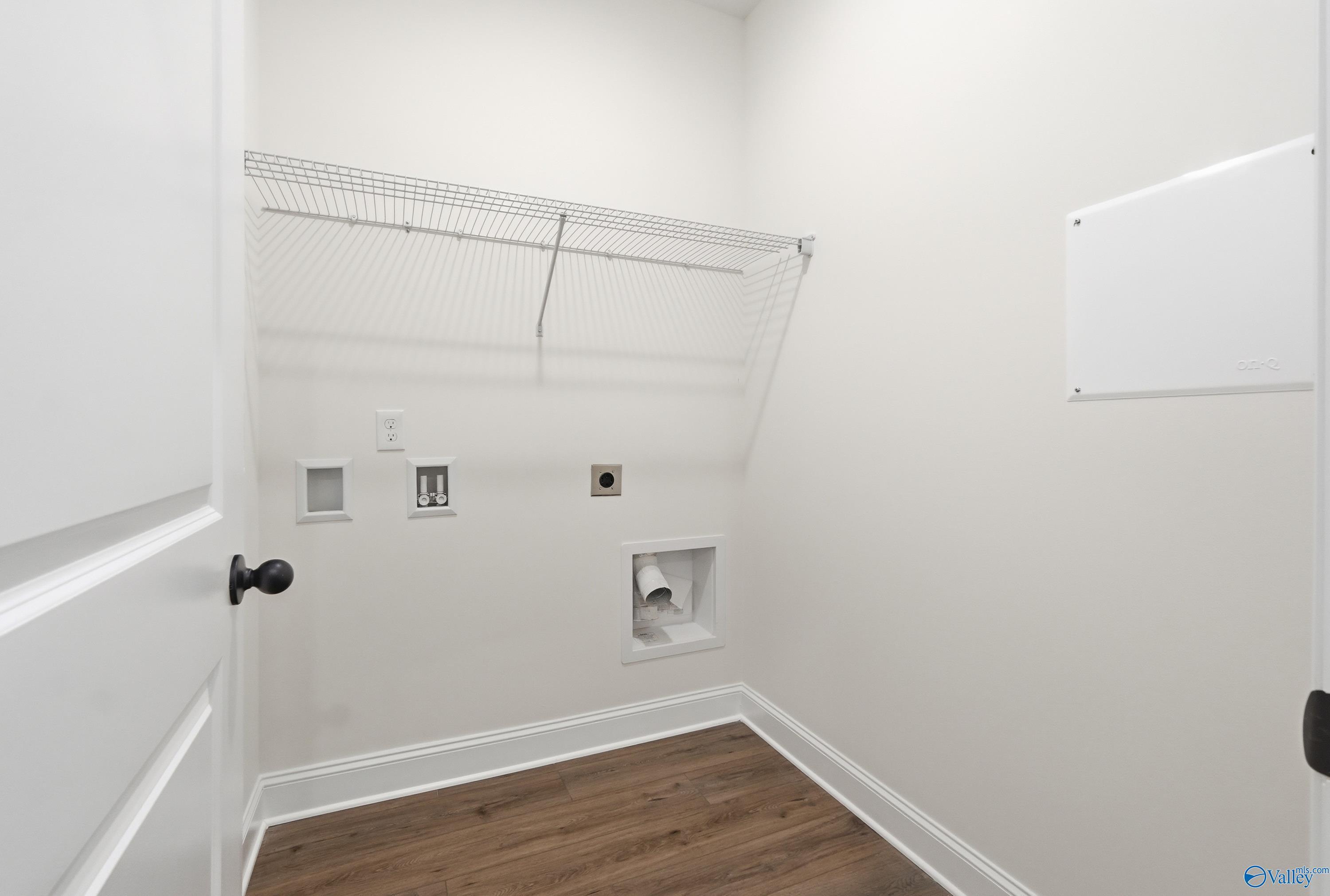 Laundry room with wire shelving and utility hookups in The Asheville C floor plan at The Highlands, Arab, Alabama.