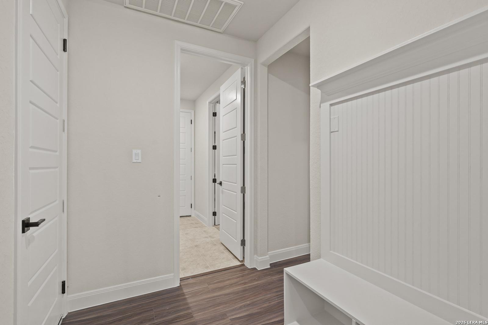 White mudroom bench with beadboard detail in the Summerlin B floor plan at Potranco Oaks, Castroville, Texas.