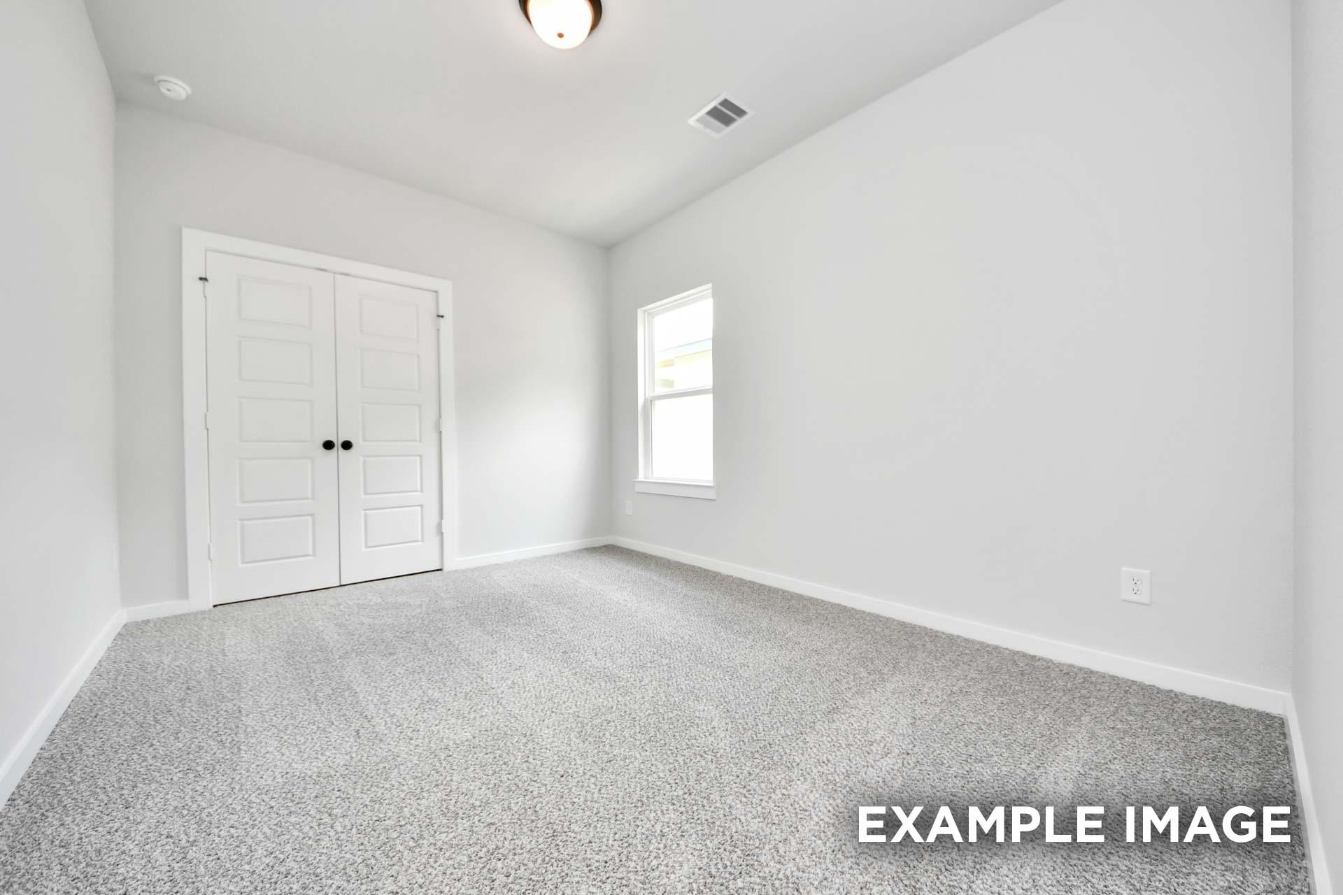 Spacious secondary bedroom in The Sorrento home design featuring neutral paint, plush carpeting, and a double-door closet.
