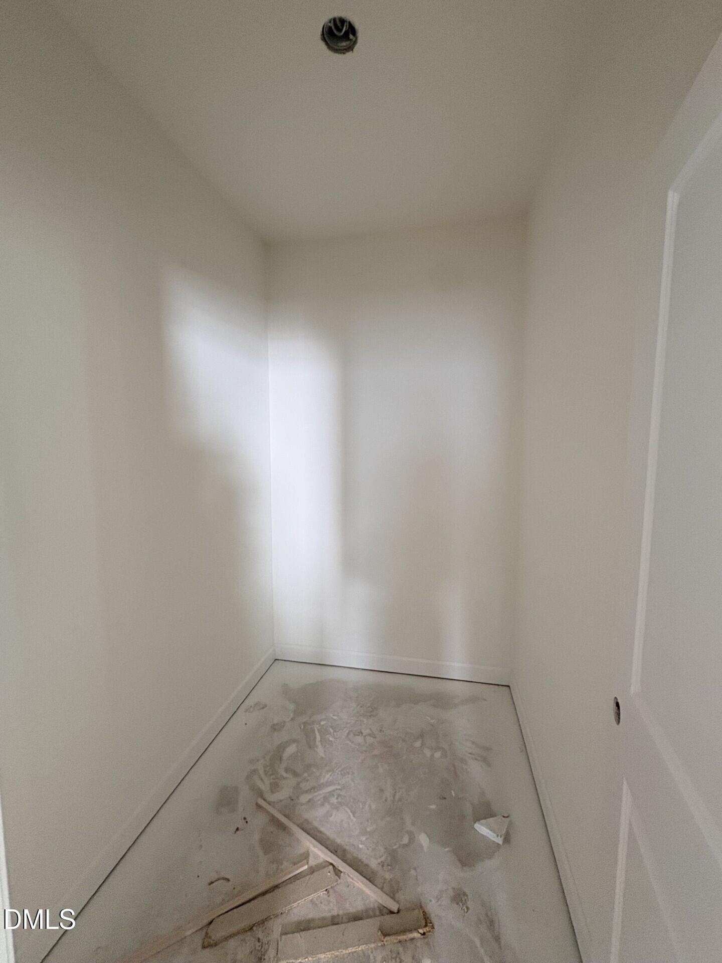 Unfinished walk-in closet with white walls and vaulted ceiling in Davidson Homes The Adalynn A, Woodland Crossing, Zebulon NC