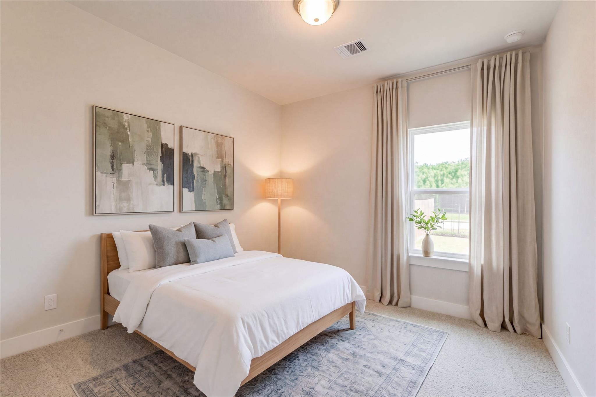 Serene bedroom with oak bed, white bedding, abstract art, and garden view through sheer curtains in Davidson Homes Luna L, Katy TX