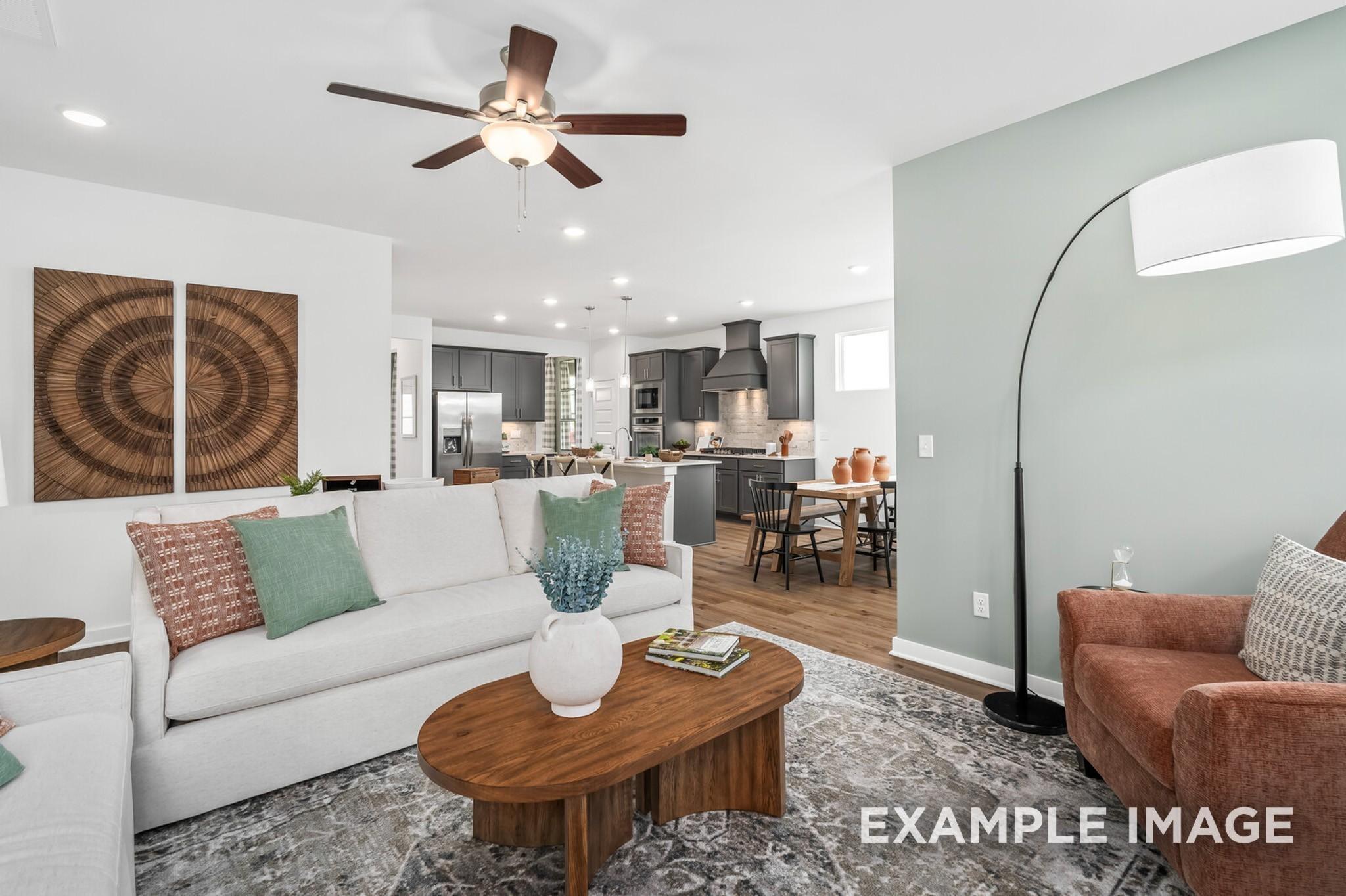Open-concept living room and kitchen in The Ash A floor plan at Woods Crossing in Gallatin, Tennessee.