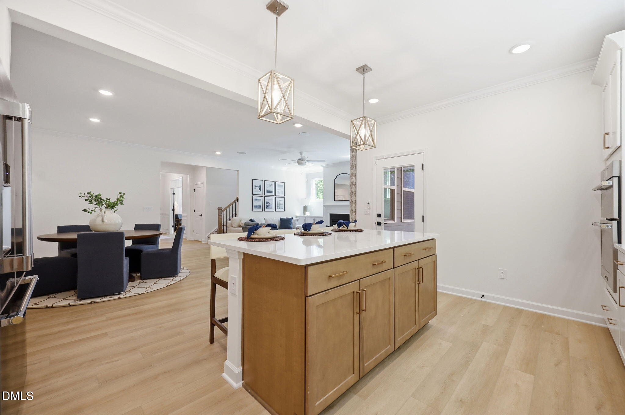 Modern kitchen island with quartz countertops and pendant lighting in The Aspen B floor plan at Wendell Ridge, NC.