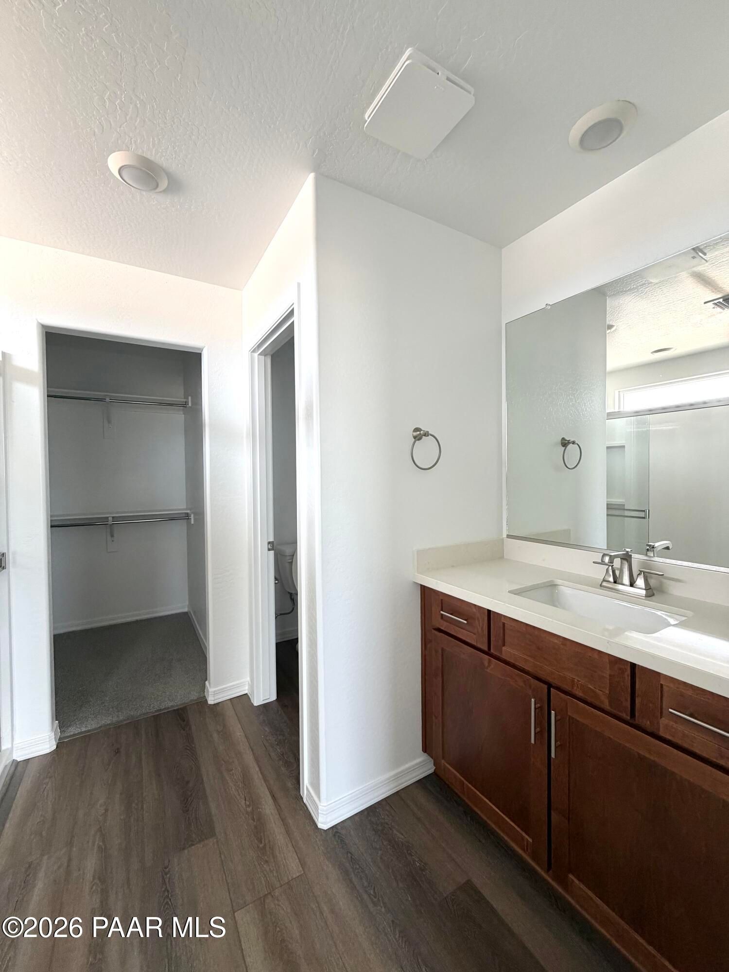Modern bathroom vanity with walk-in closet in The Raleigh A floor plan at South Ranch, Prescott, Arizona.
