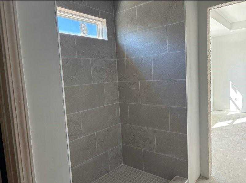 Modern gray tiled walk-in shower with clerestory window in master bath, The Rabun C by Davidson Homes, Cedar Farms Winder GA