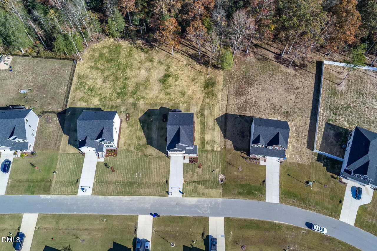 Aerial view of modern two-story homes with two-car garages and autumn wooded lots in Wellers Knoll, Lillington, North Carolina, by Davidson Homes