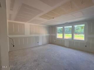 Unfinished living area with drywall and large windows in The Hickory II B floor plan at Woodland Crossing, Zebulon, NC.