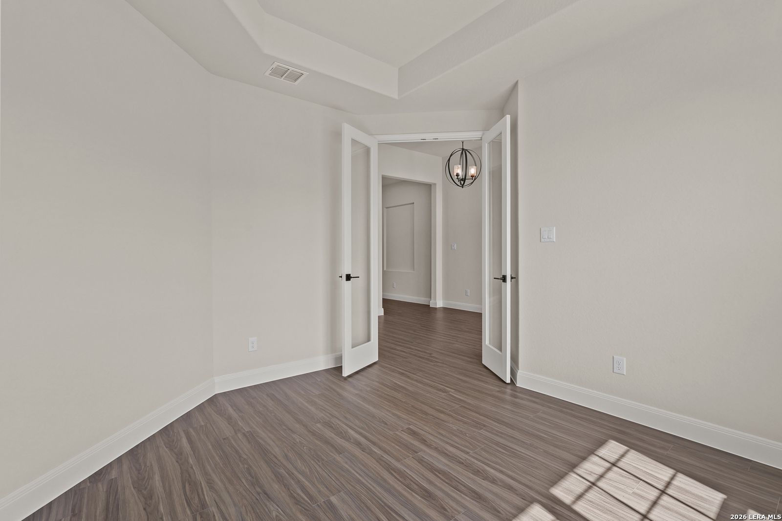 French doors leading to a flex room with tray ceiling in The Summerlin B floor plan by Davidson Homes, Potranco Oaks.