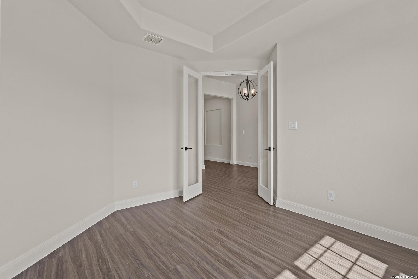 French doors leading to a flex room with tray ceiling in The Summerlin B floor plan by Davidson Homes, Potranco Oaks.