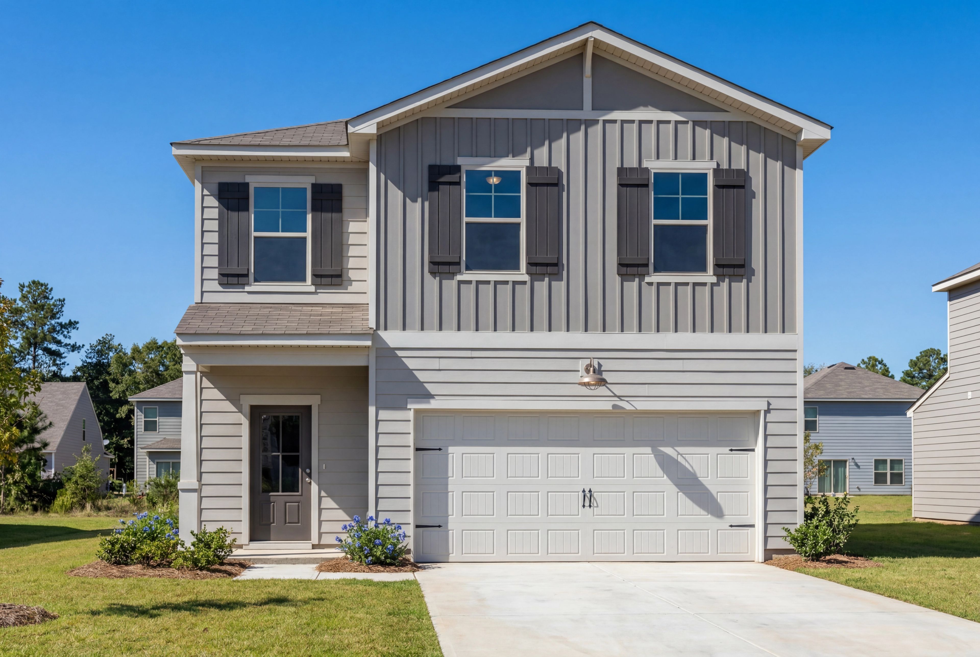 Two-story exterior elevation of The Rabun B by Davidson Homes featuring gray siding, shutters, and a 2-car garage.
