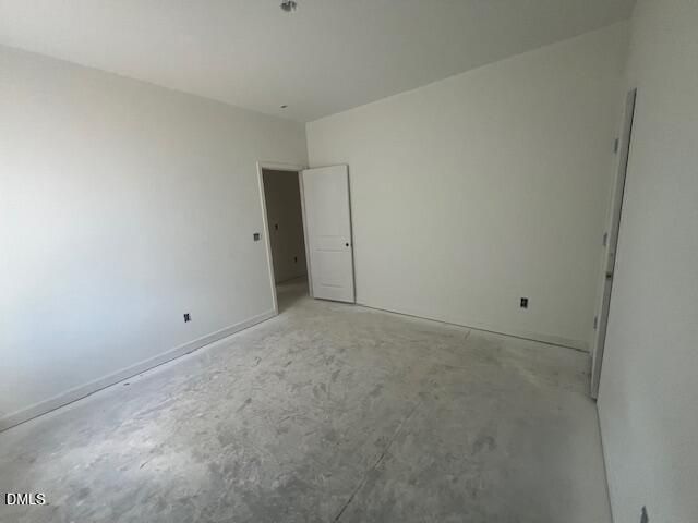 Spacious empty bedroom with fresh white walls and open doorway in new Davidson Homes Magnolia II B plan, Lillington NC