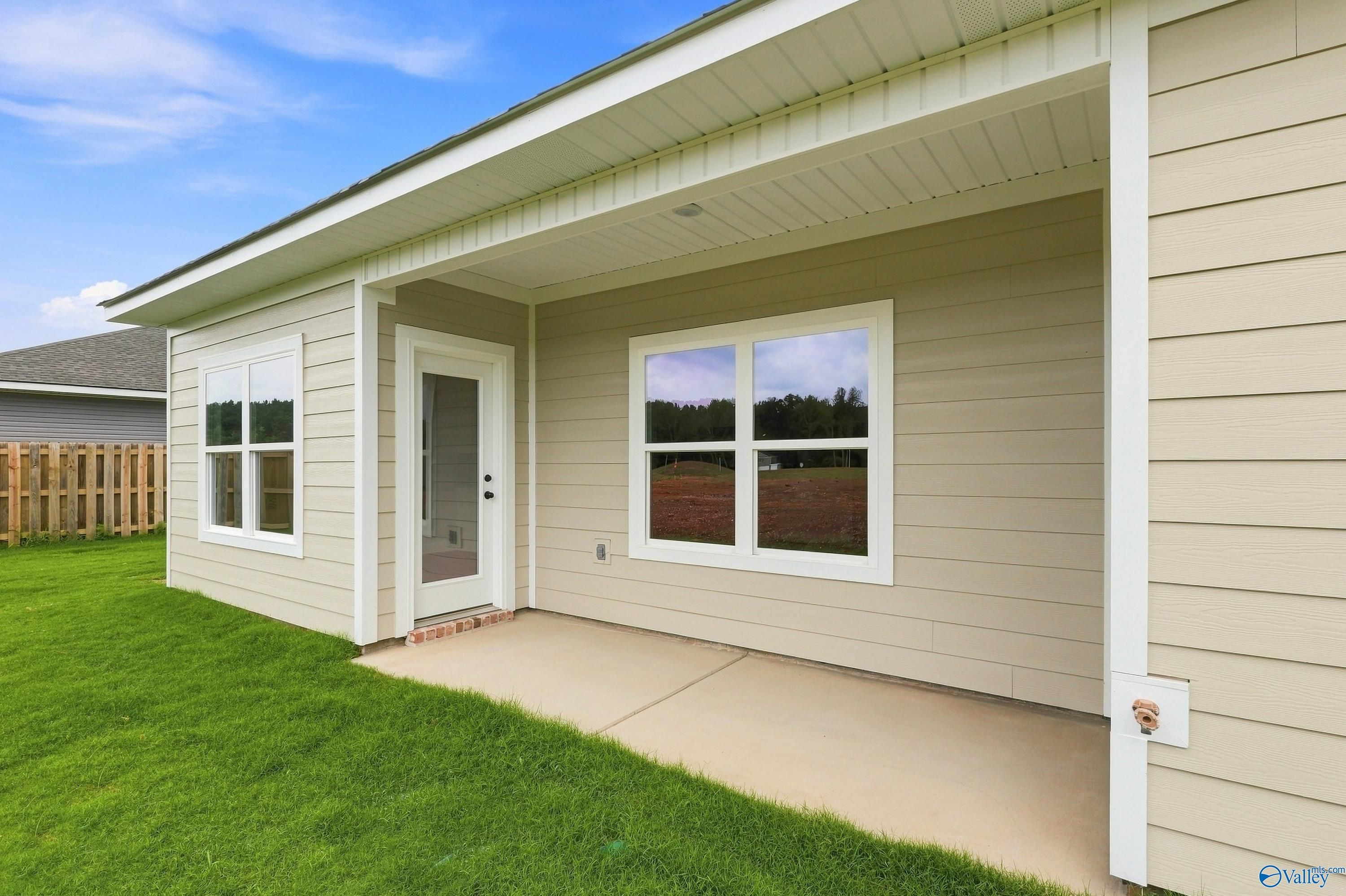 Covered concrete patio at The Asheville E floor plan by Davidson Homes in Forest Glen, Hazel Green, Alabama.