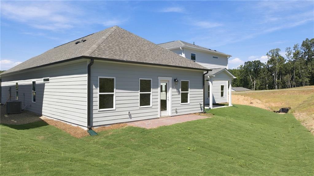 Gray siding single-story home with covered patio and fenced backyard in The Bluffs, Canton, Georgia by Davidson Homes
