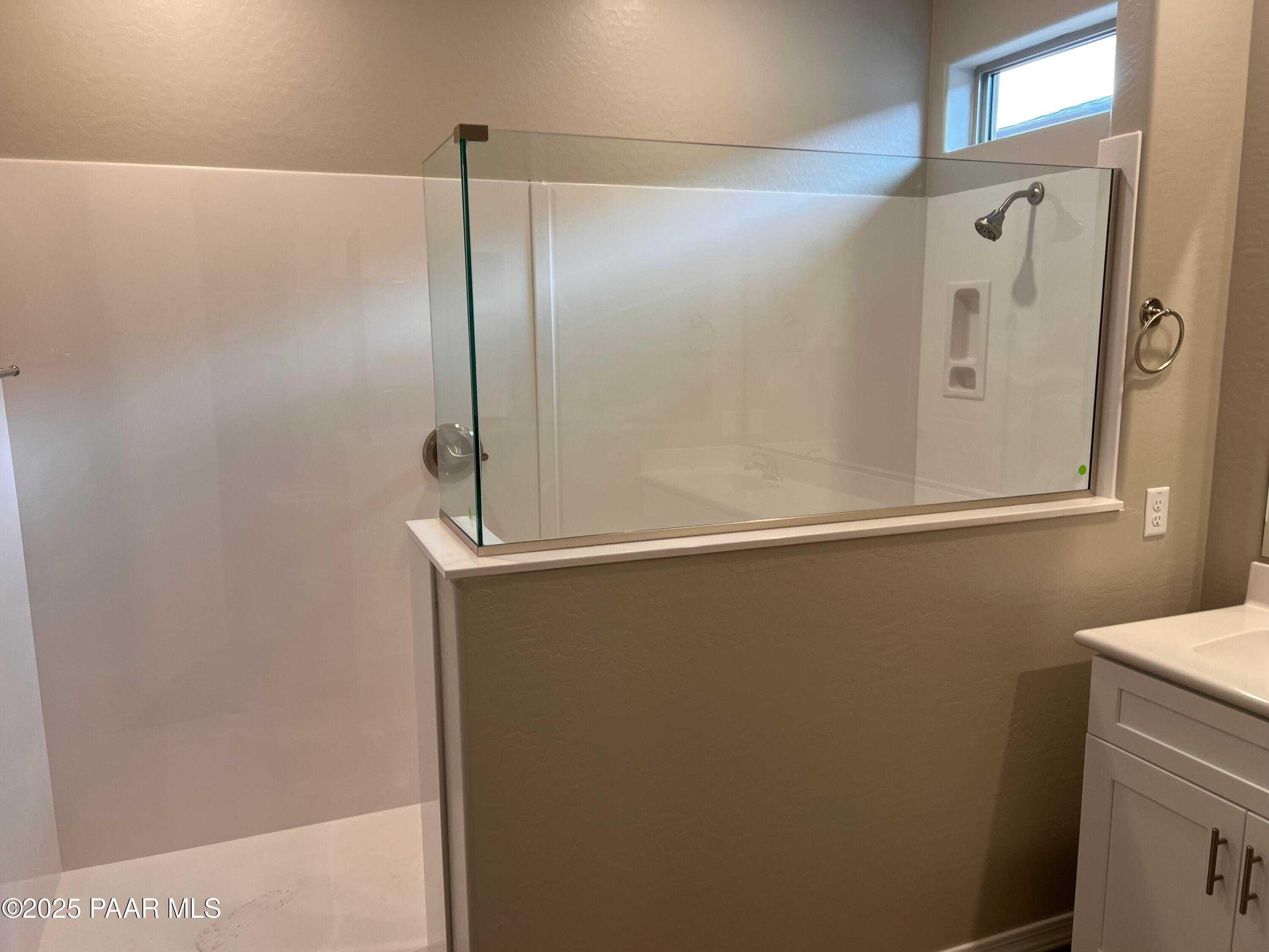 Modern walk-in shower with glass enclosure, white subway tiles, and rainfall head in master bath of Davidson Homes The Harmony A, Prescott Valley, AZ