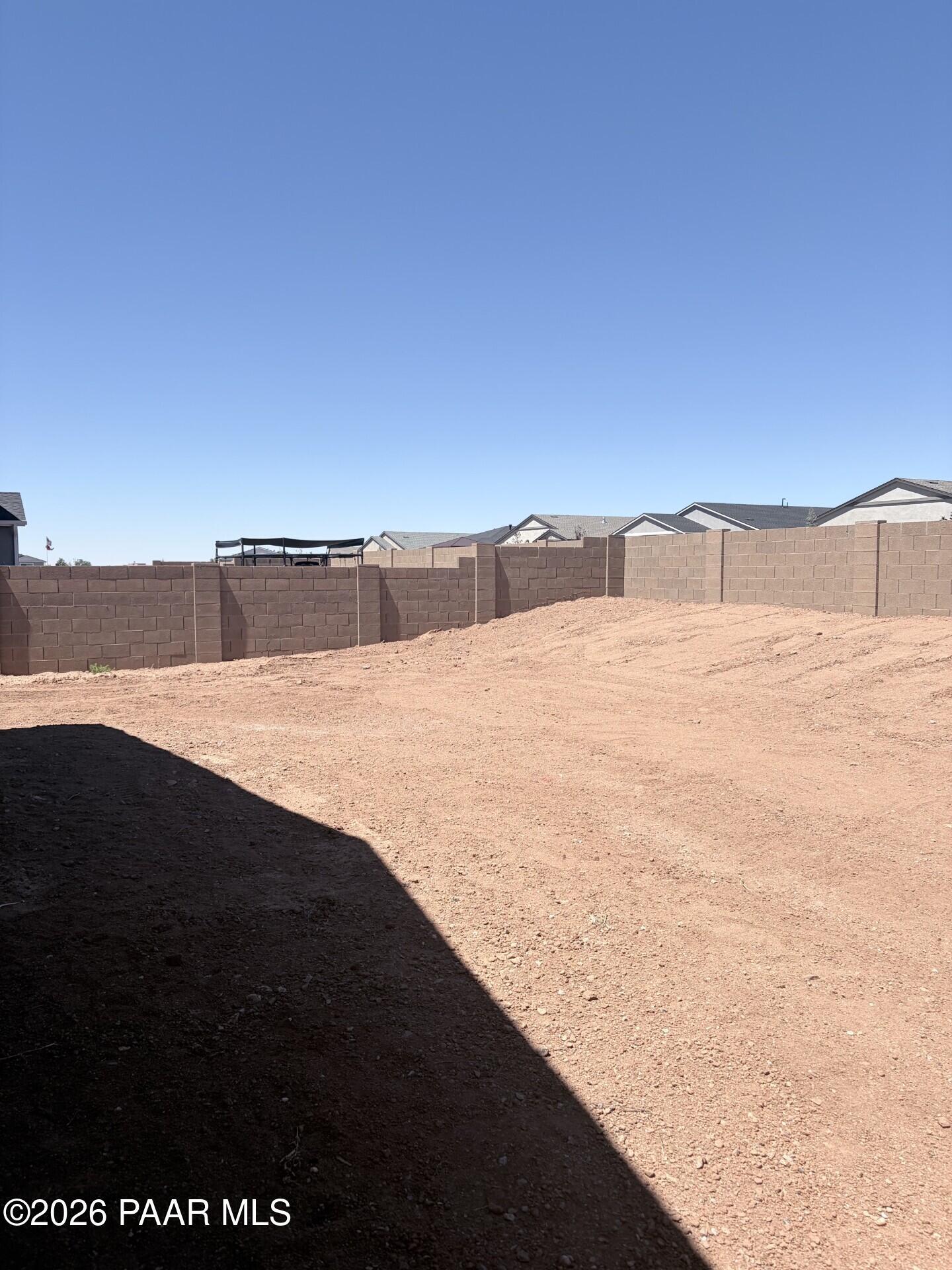Unfinished backyard with block wall fencing at The Frontier A home in North Ridge at Pronghorn Ranch, Prescott Valley, AZ.