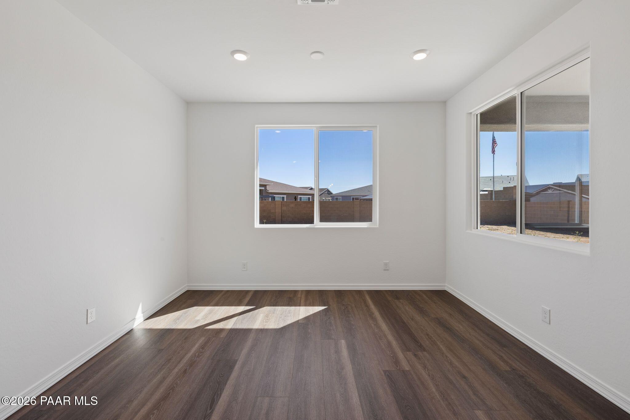 Bright living room with large windows, hardwood floors, and sunny Arizona views in Davidson Homes The Monarch A, Prescott