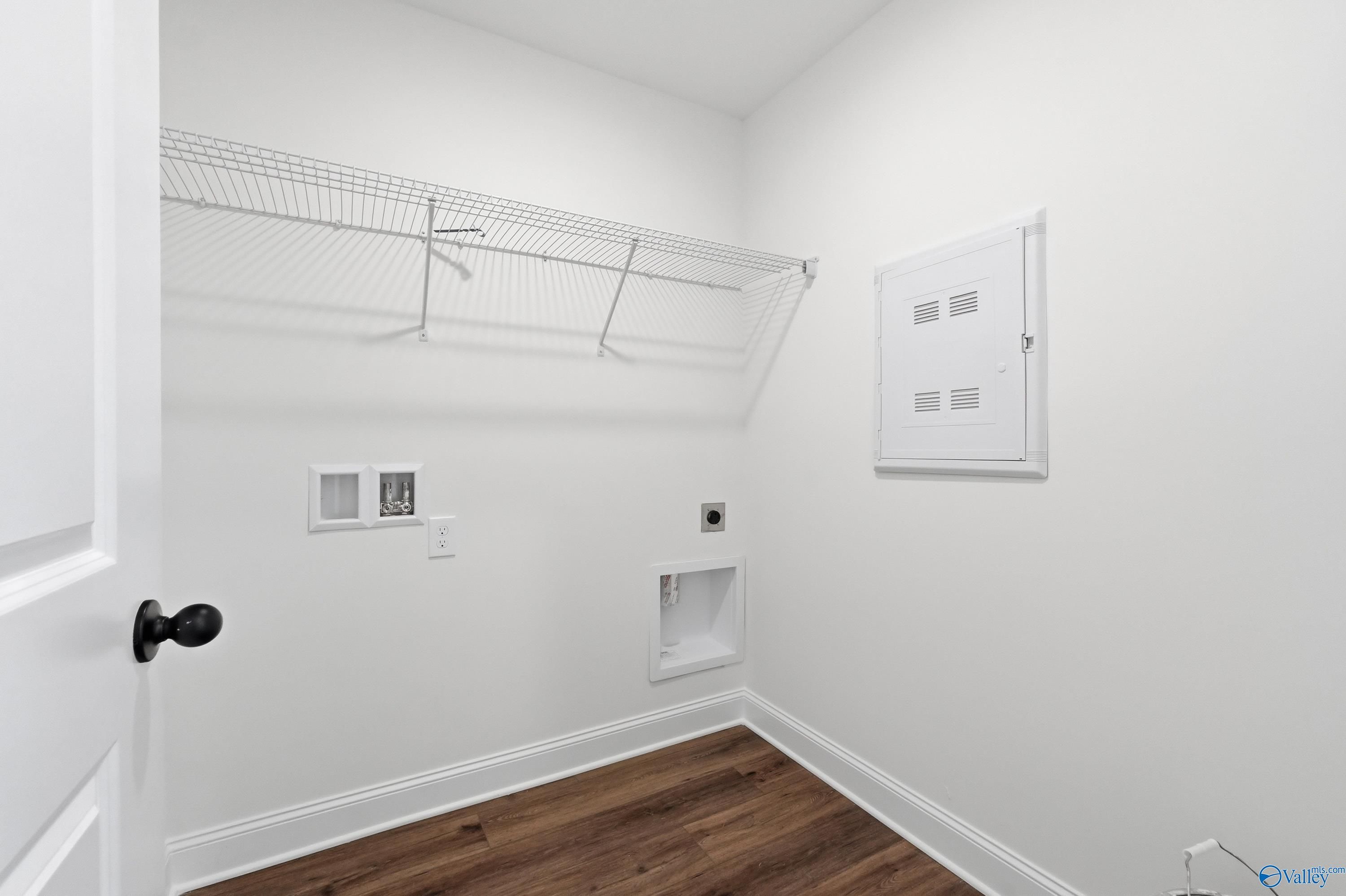 Dedicated laundry room with wire shelving and utility hookups in The Franklin floor plan at Heritage Lakes, New Market.