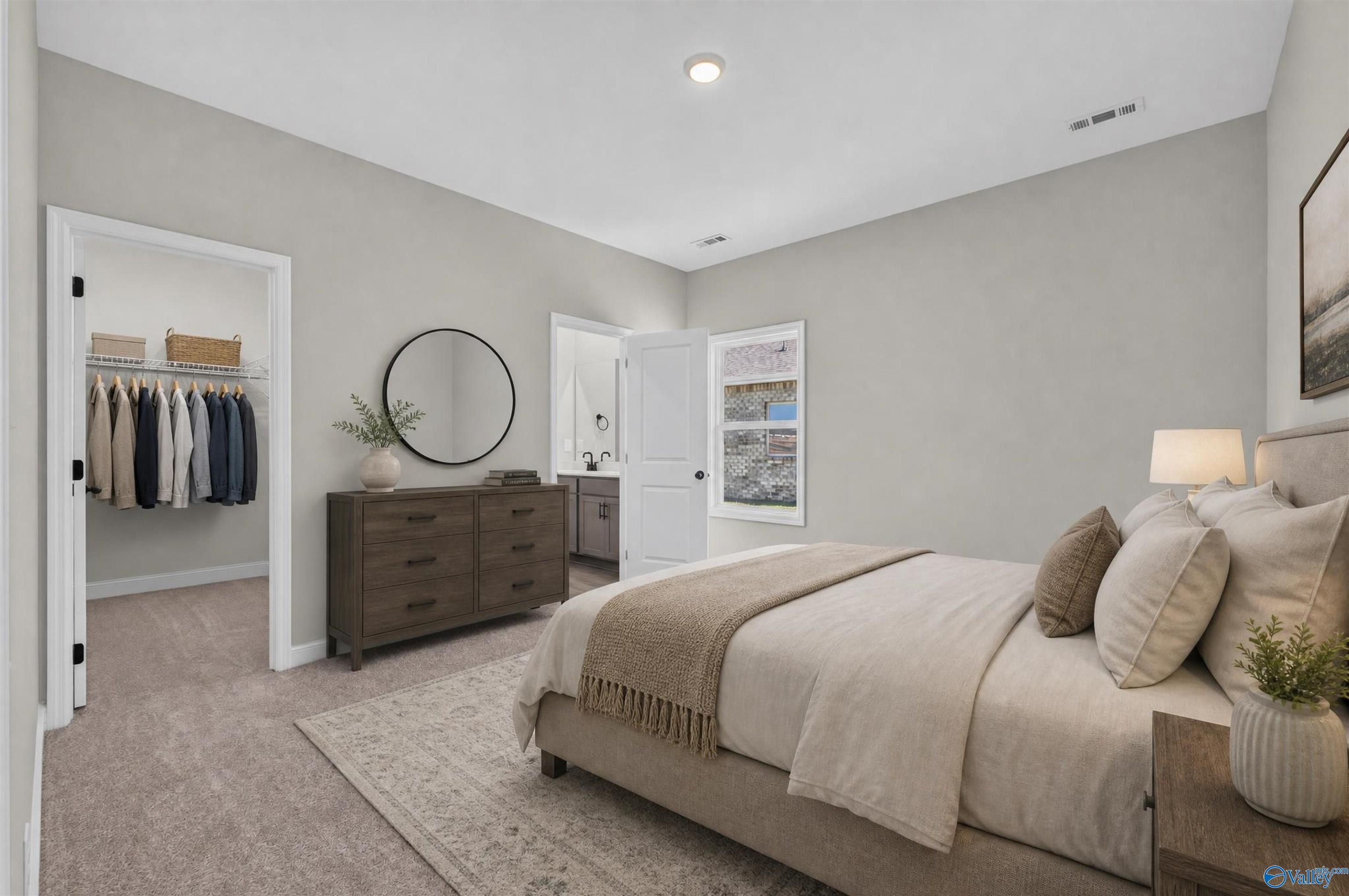 Serene primary bedroom with walk-in closet and en-suite bath in Davidson Homes The Butler plan, Heritage Lakes, New Market, Alabama