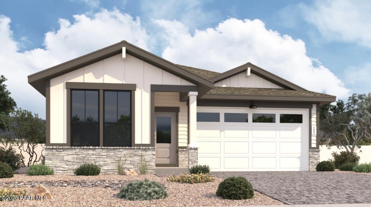 Modern 1-story Nantucket B home exterior with 3-car garage, stone accents, large windows, and desert landscaping in Prescott, Arizona