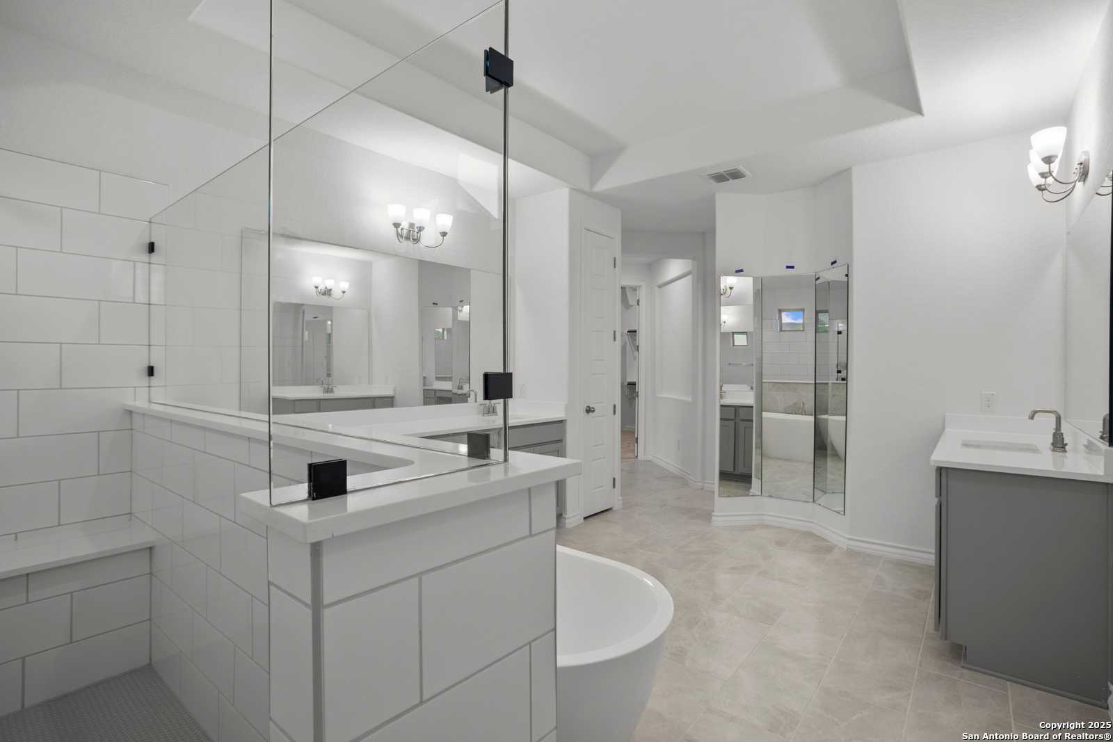 Modern master bathroom with freestanding tub, glass shower, double vanity in Davidson Homes Summerlin B, Castroville, Texas