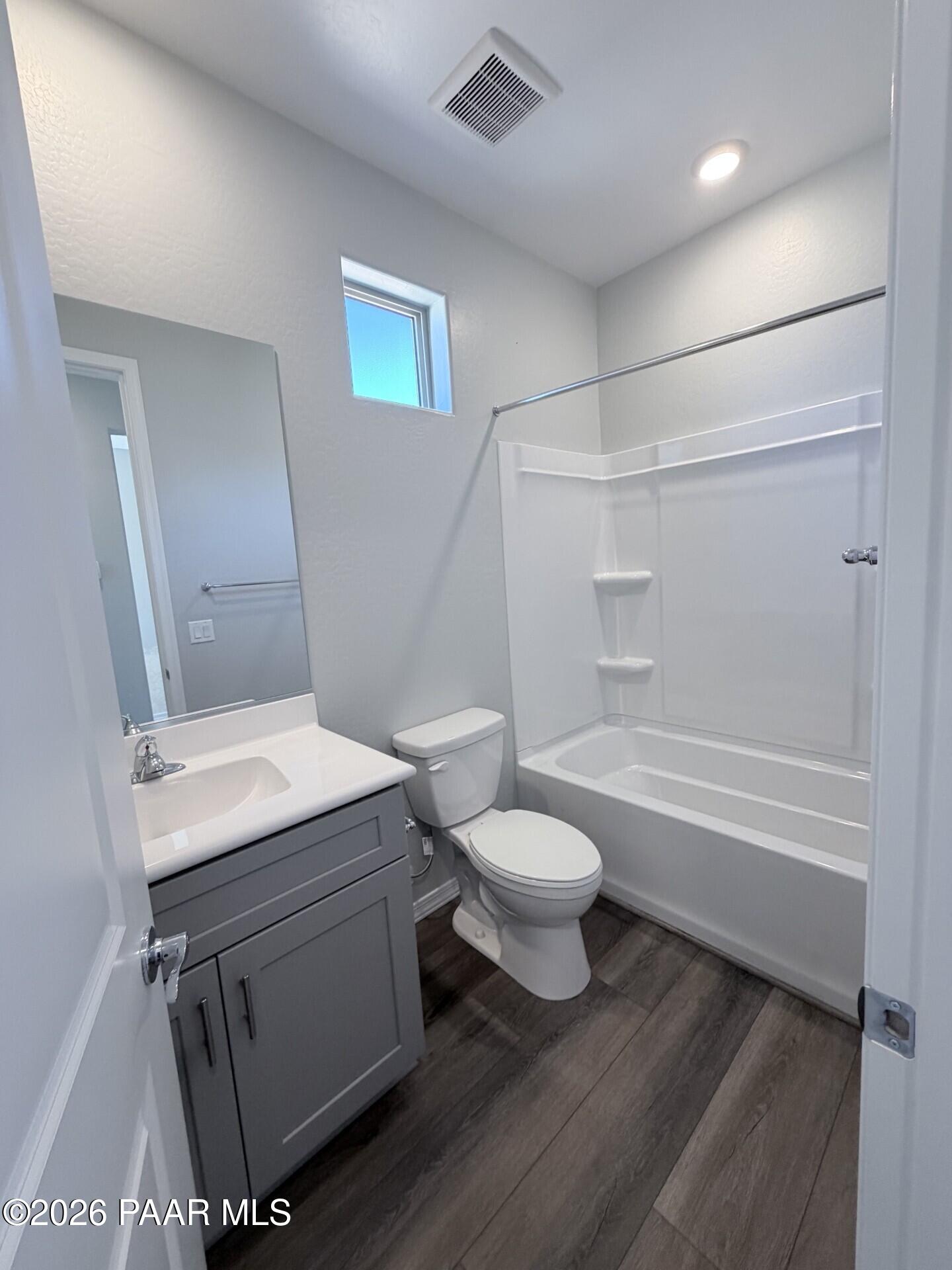 Modern bathroom with gray vanity and tub-shower combo in The Frontier A floor plan at North Ridge, Prescott Valley, AZ.