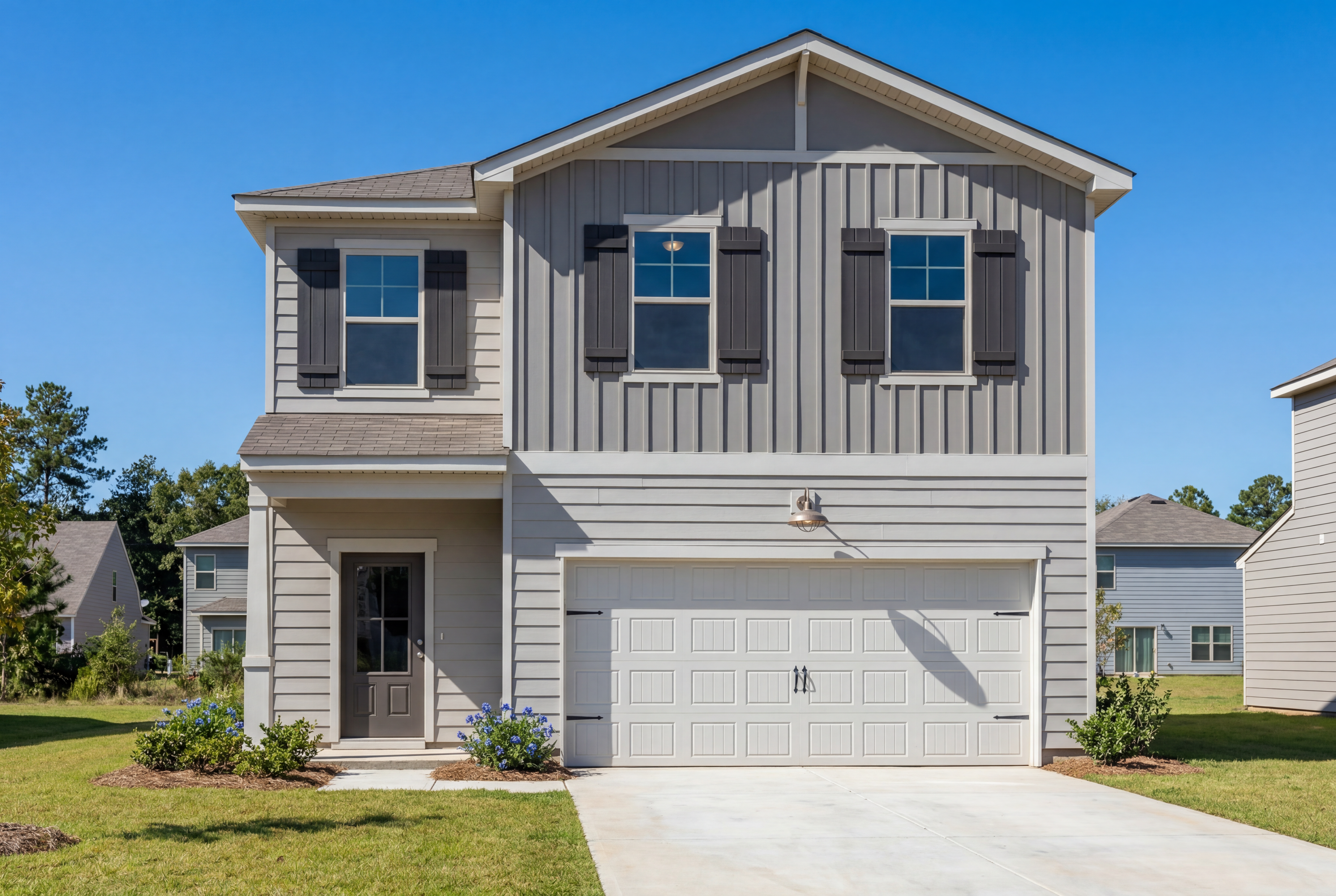 Two-story exterior elevation of The Rabun B by Davidson Homes featuring gray siding, shutters, and a 2-car garage.