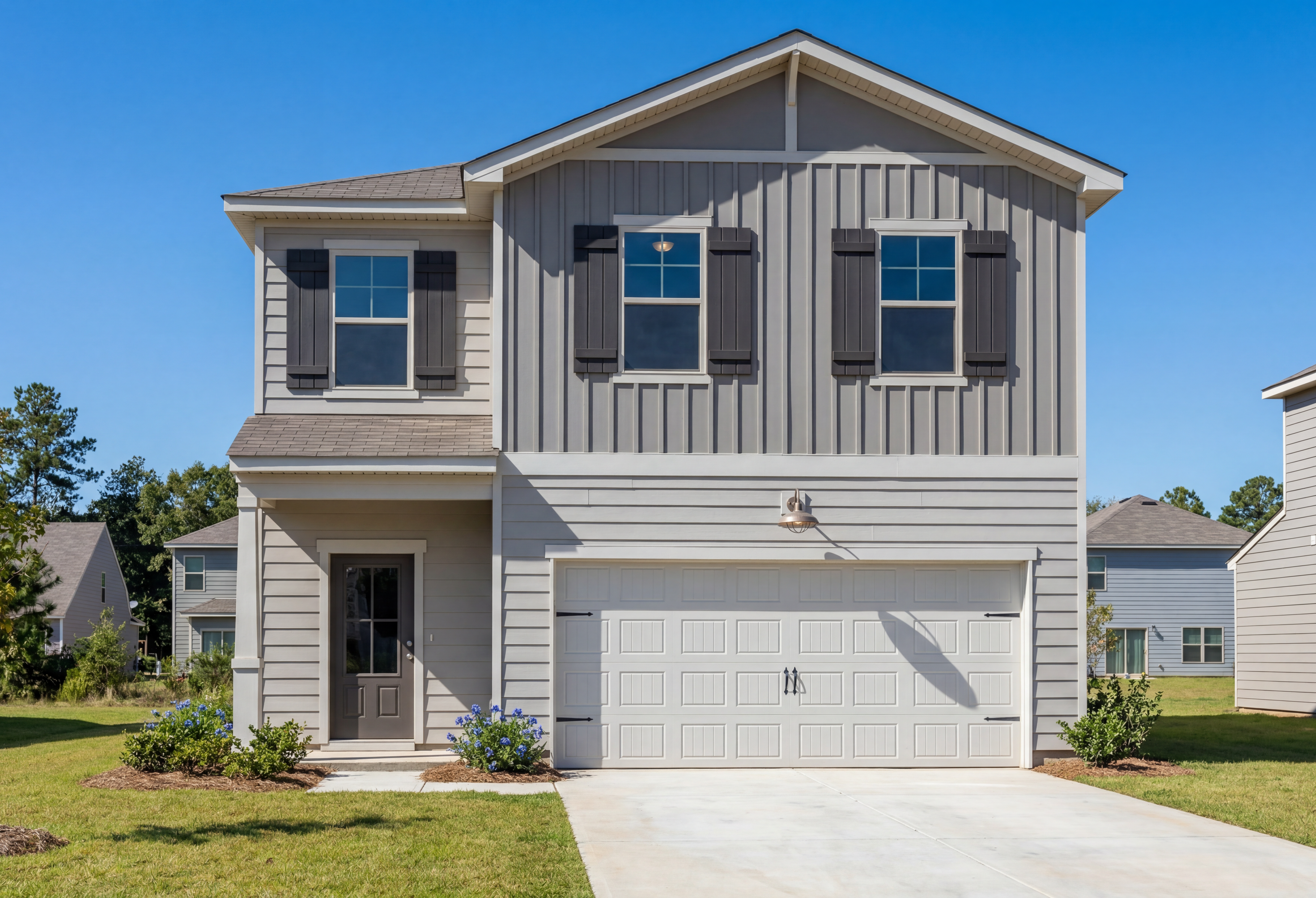 Two-story exterior elevation of The Rabun B by Davidson Homes featuring gray siding, shutters, and a 2-car garage.