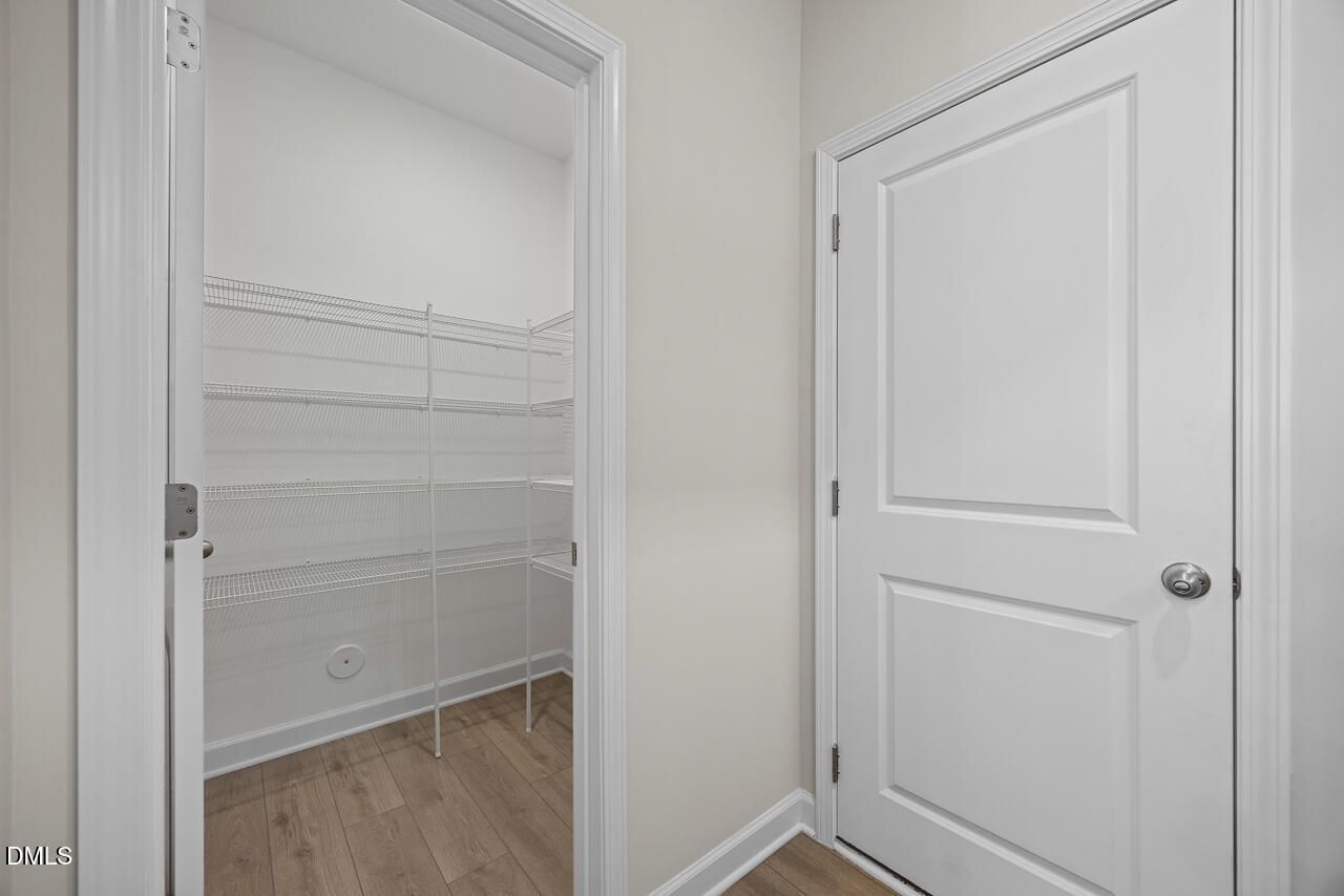 Walk-in pantry with white wire shelving in The Gavin A floor plan at Gregory Village, Lillington, North Carolina.