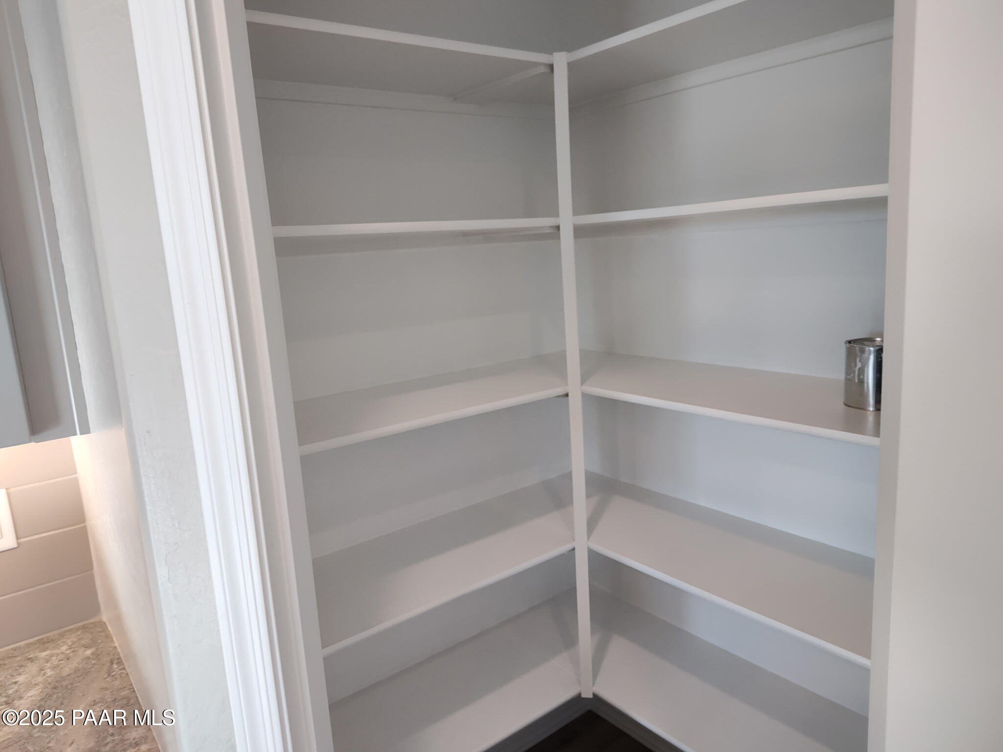 Spacious corner walk-in pantry with white wire shelves in Davidson Homes The Frontier C, Prescott Valley, Arizona
