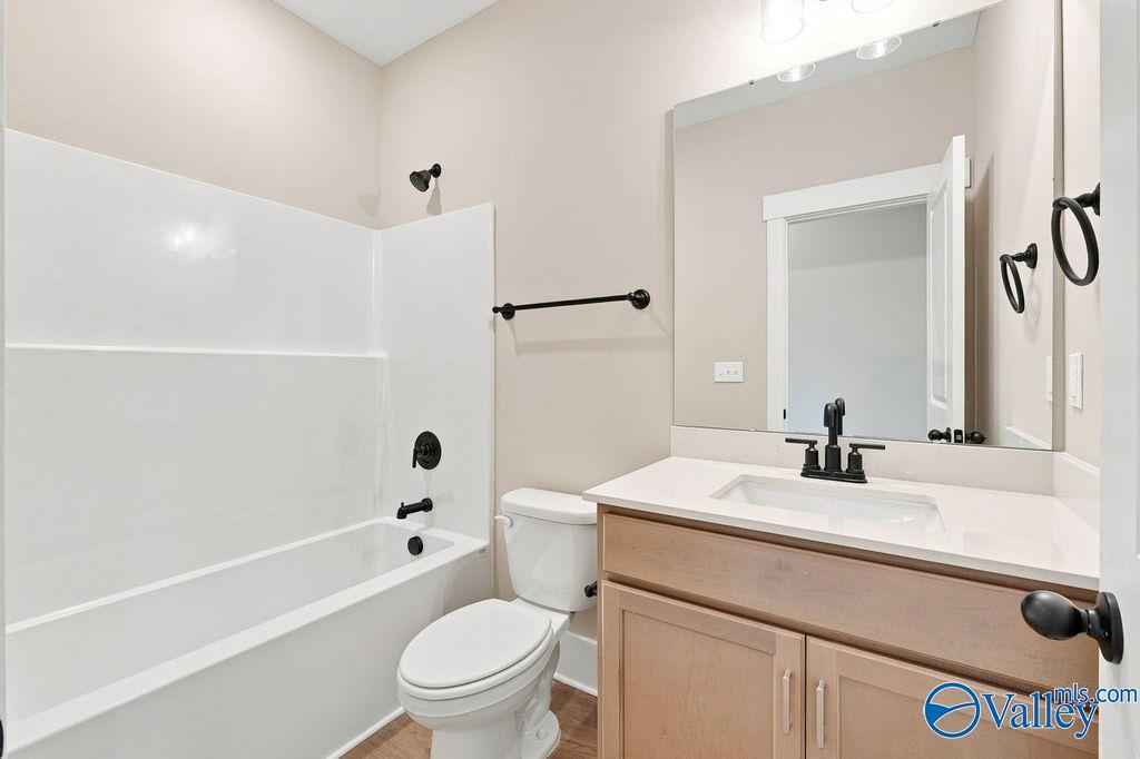 Modern bathroom with tub-shower combo and vanity in The Rockford floor plan at Cain Park, Hartselle, Alabama.