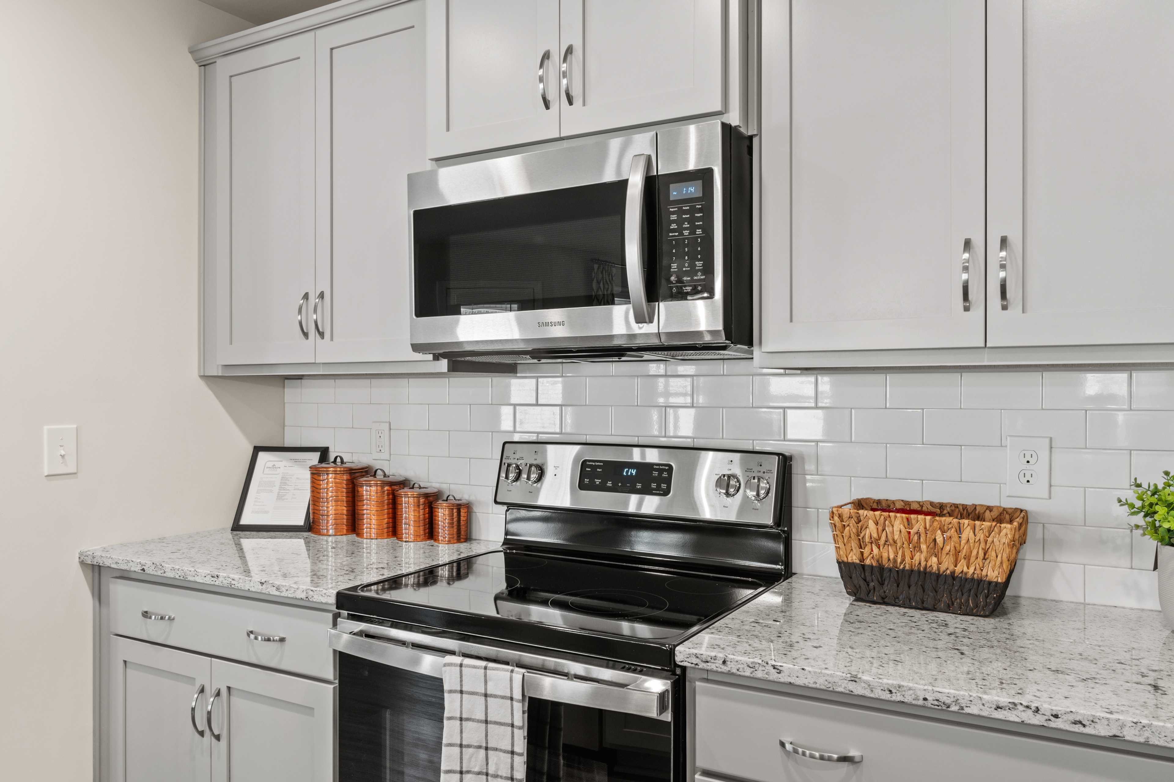 Spacious Ramsay Cove kitchen in Owens Cross Roads AL with white shaker cabinets, stainless steel appliances, subway tile backsplash