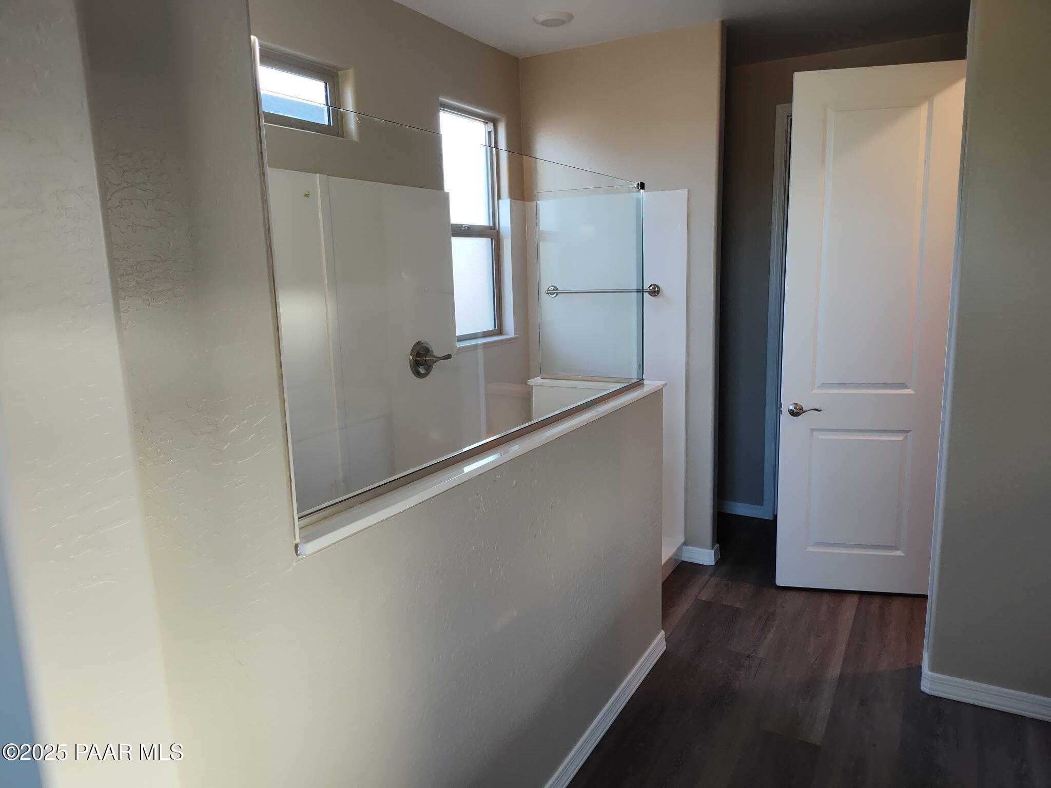 Modern master bathroom with frameless glass shower enclosure and beige walls in Davidson Homes The Frontier A, Prescott Valley, AZ