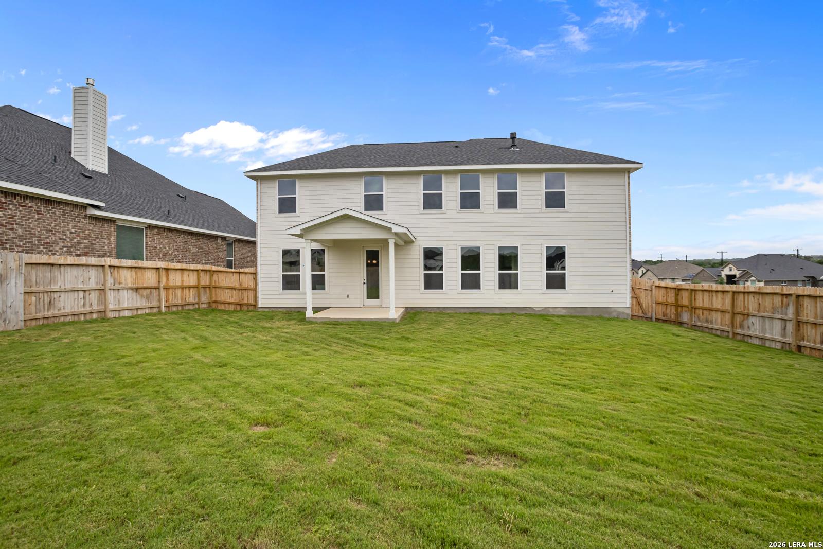 Spacious backyard and covered patio of The Danbury H floor plan by Davidson Homes in The Reserve at Potranco Oaks, Texas.