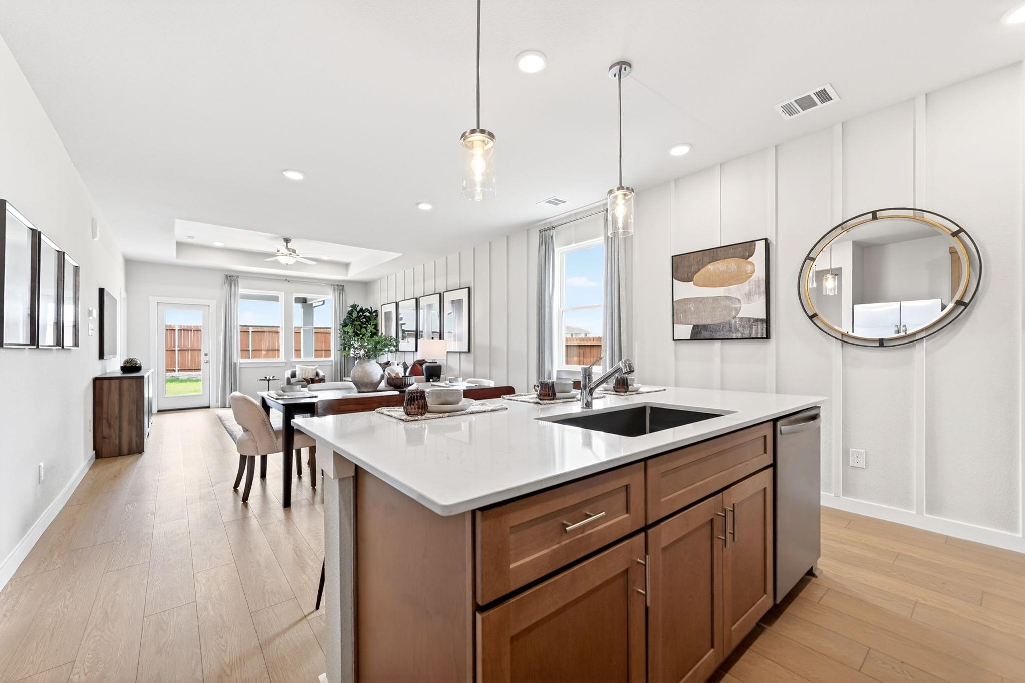 Open-concept kitchen and dining area at Mesa Vista in San Antonio with Davidson Homes’ signature modern wood cabinetry.