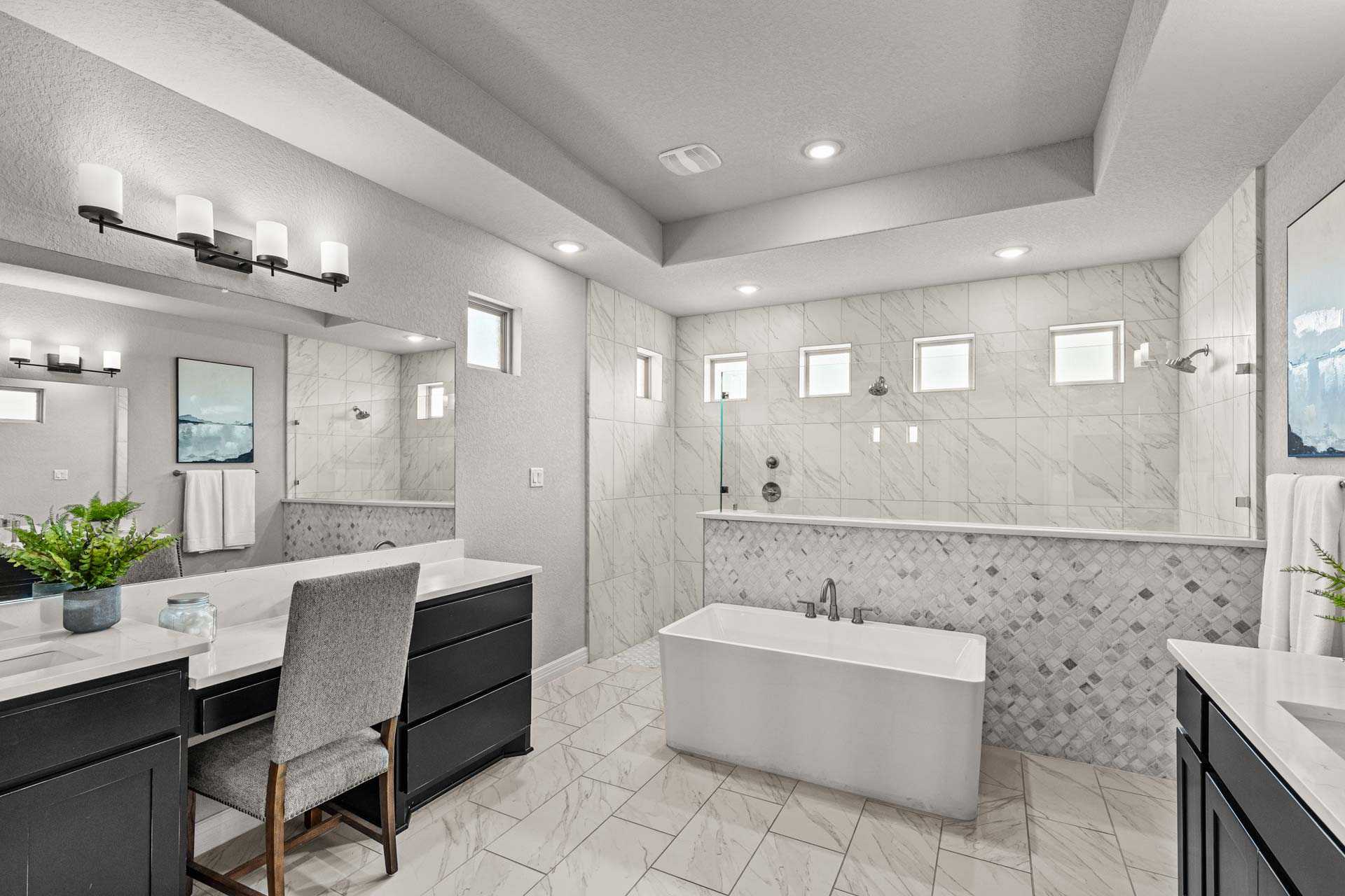 Spacious master bathroom in The Summerlin B with freestanding tub, double vanity, tiled shower, and modern fixtures