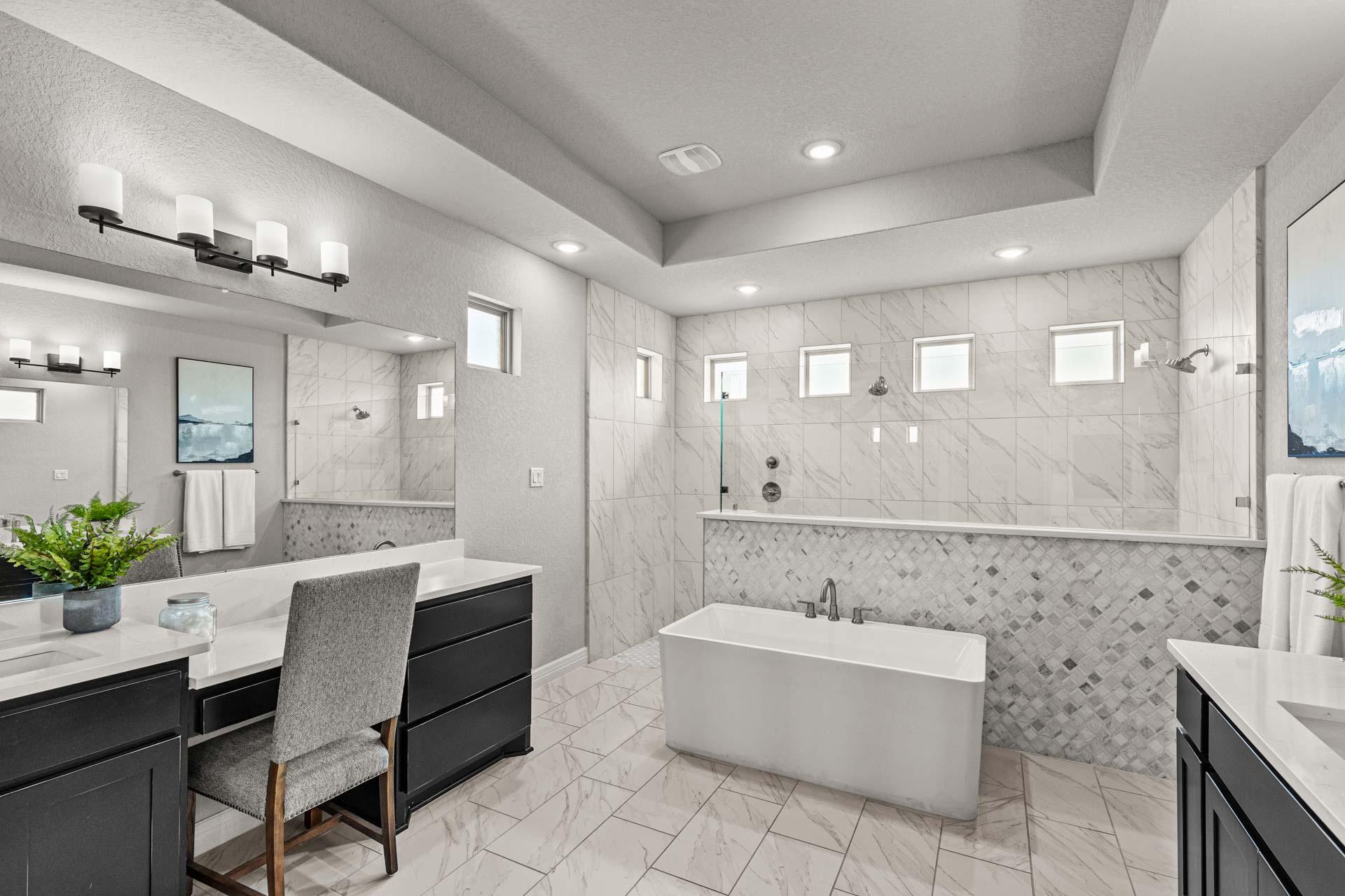 Luxurious primary bathroom at Potranco Oaks in Castroville Texas with freestanding tub, double vanity, and tiled accents